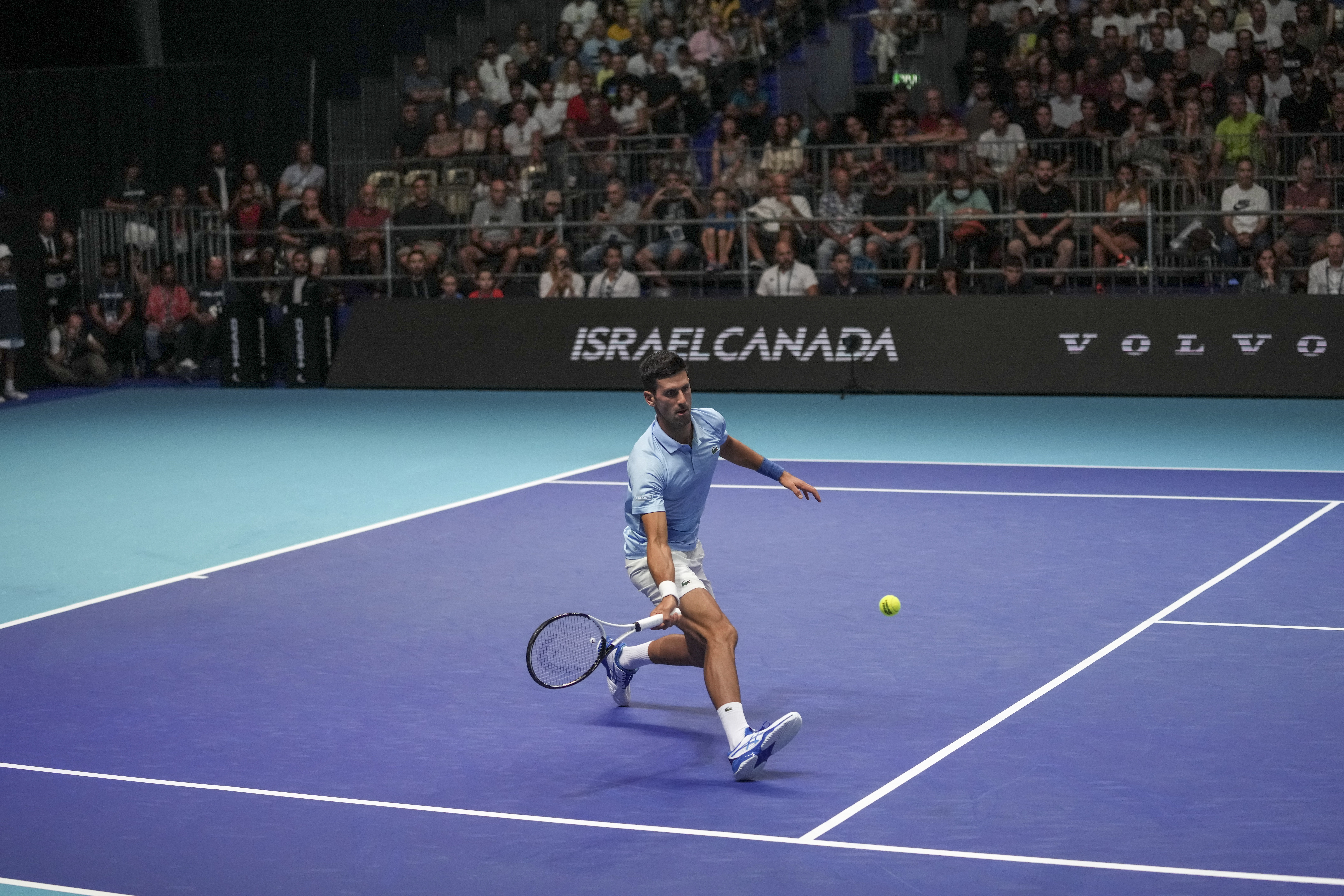 Serbia's Novak Djokovic returns to Canada's Vasek Pospisil during the quarterfinals of the ATP 250 Tel Aviv open tennis match in Tel Aviv, Israel, Friday, Sept. 30, 2022. (AP Photo/Ariel Schalit)