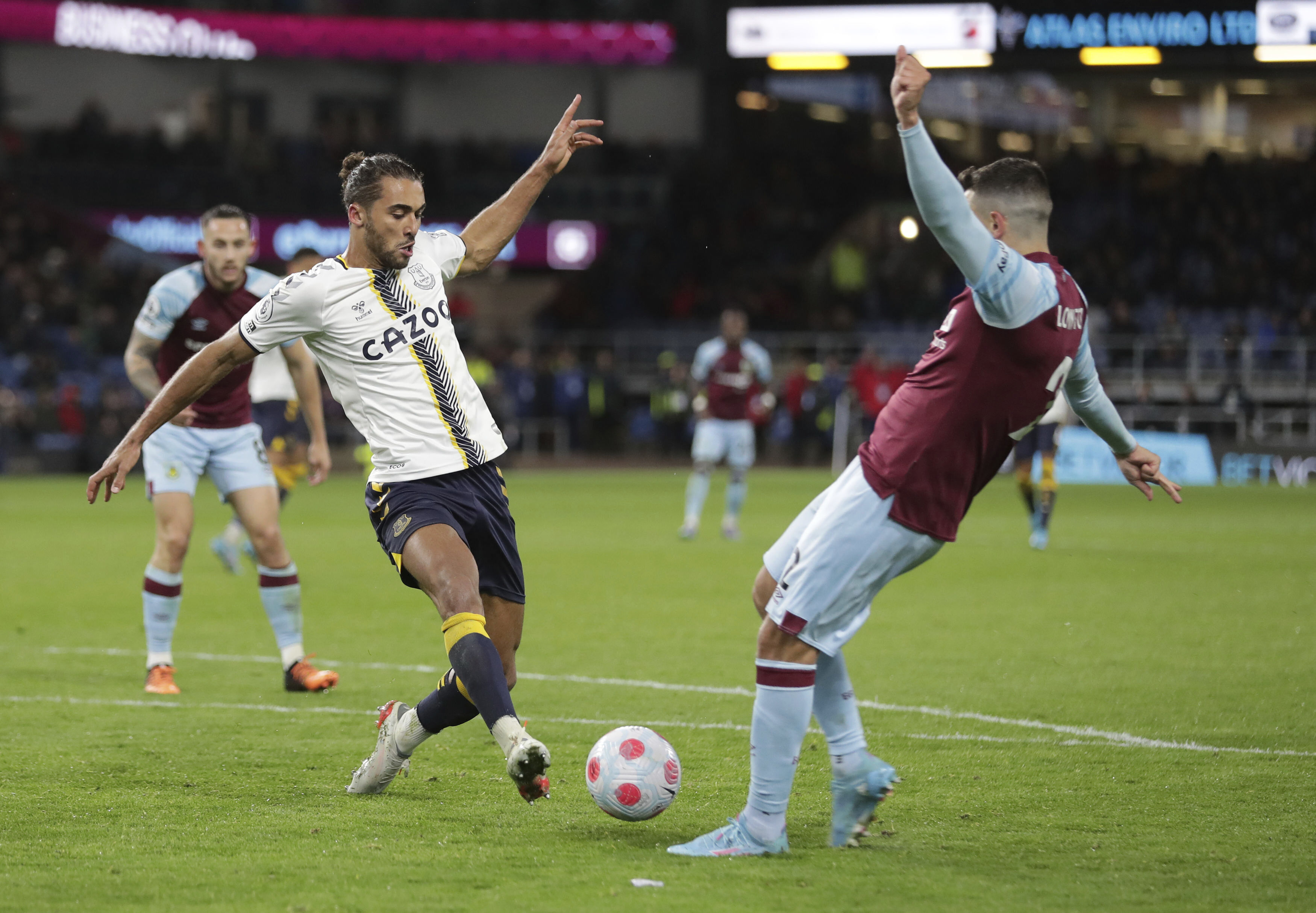 Everton's Dominic Calvert-Lewin and Burnley's Matthew Lowton, right, battle for the ball  during the English Premier League soccer match between Burnley and Everton at Turf Moor, in Burnley, England, Wednesday April 6, 2022. (Richard Sellers/PA via AP)