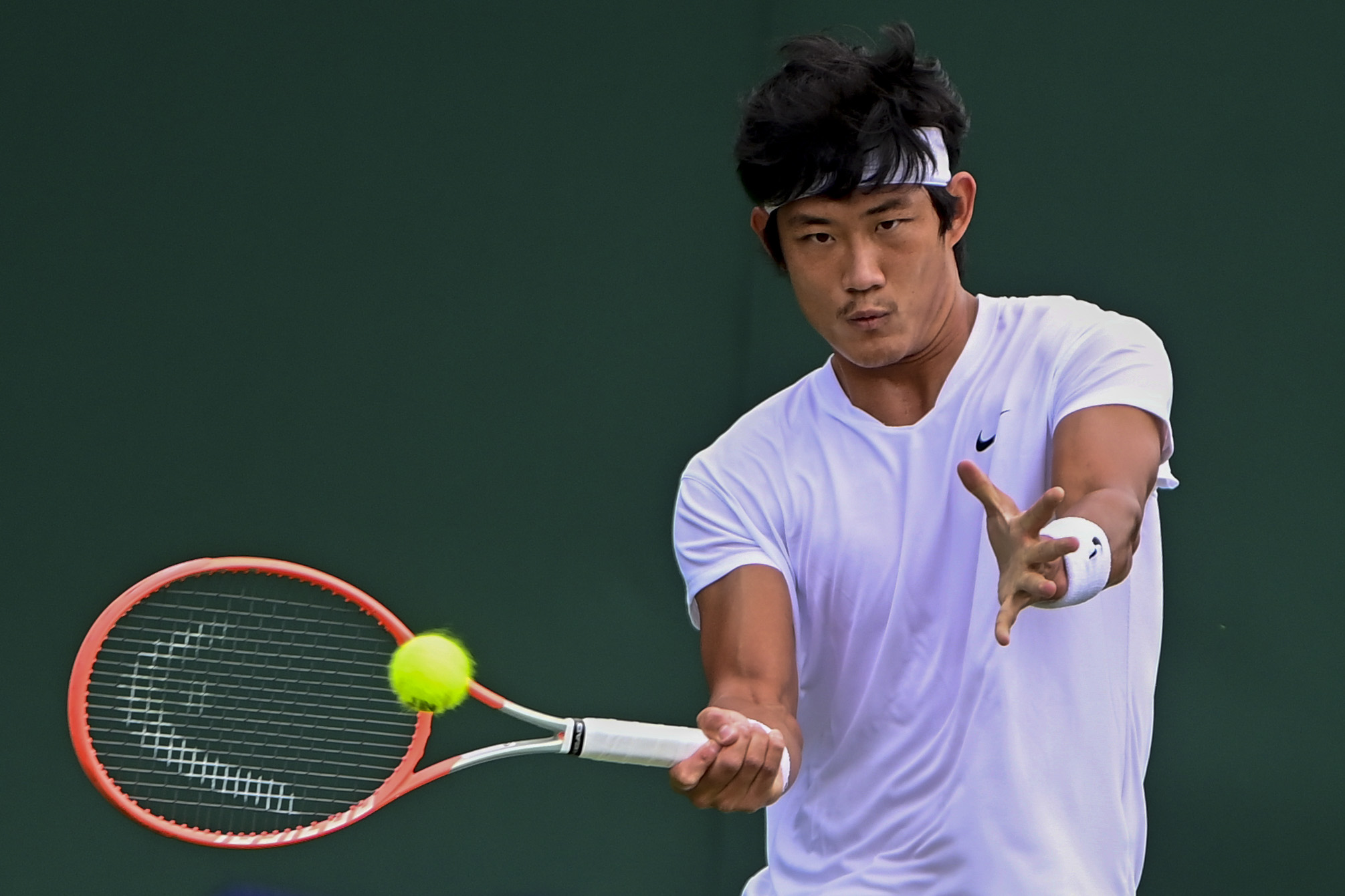 epa09310529 Zhizhen Zhang of China in action against Antoine Hoang of France during their 1st round match at the Wimbledon Championships, Wimbledon, Britain 29 June 2021.  EPA-EFE/NEIL HALL