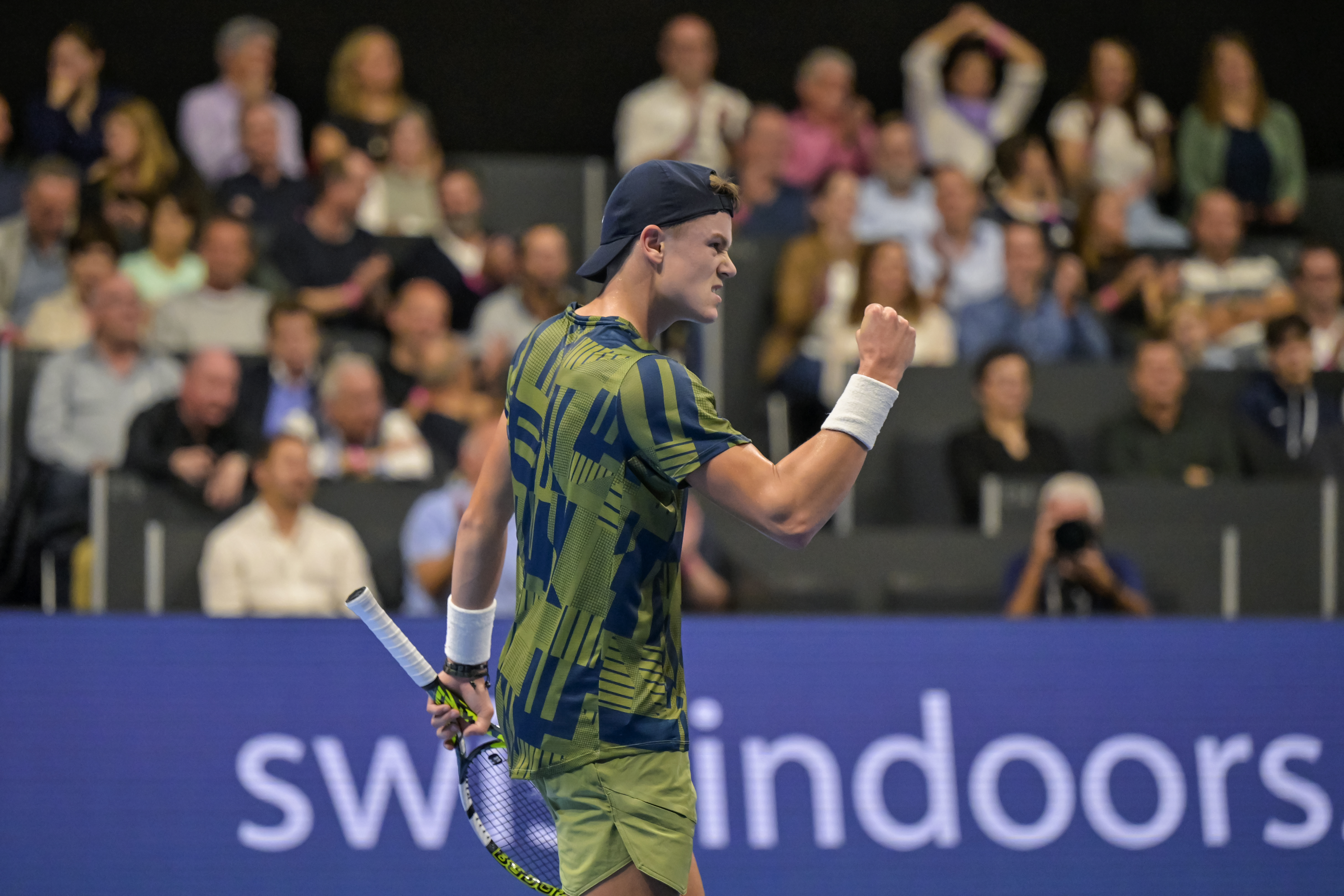 epa10273469 Denmark's Holger Rune cheers after winning the first set of his semifinal match against Spain's Roberto Bautista Agut at the Swiss Indoors tennis tournament in Basel, Switzerland, 29 October 2022.  EPA-EFE/GEORGIOS KEFALAS