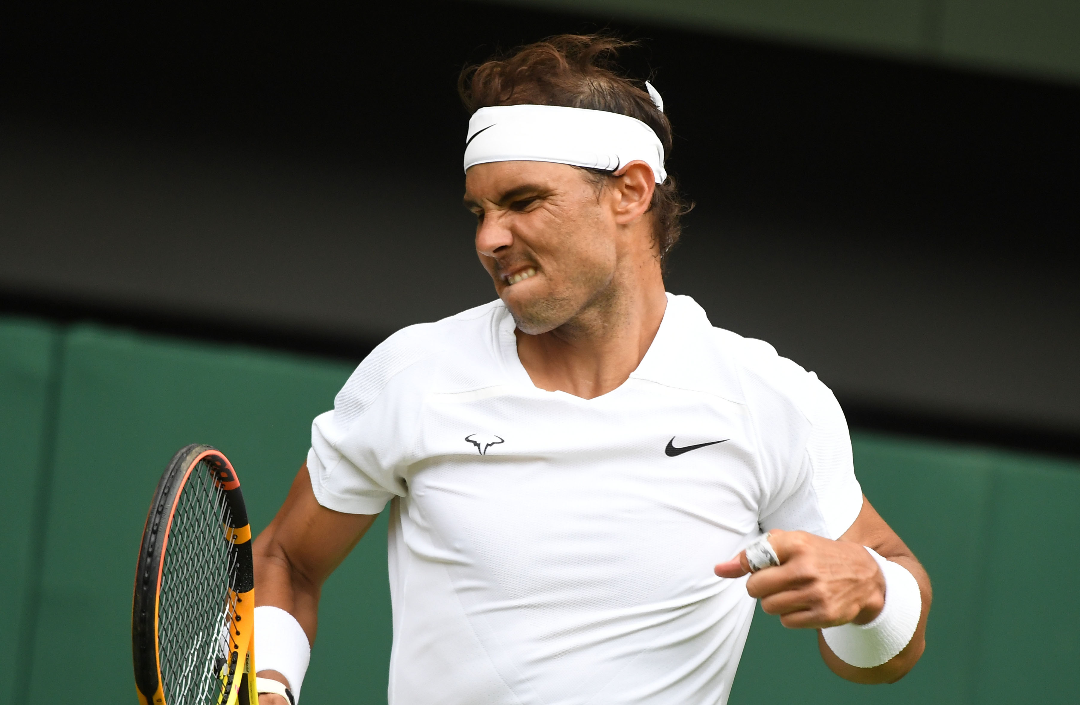 epa10039132 Rafael Nadal of Spain celebrates a point in the men's first round match against Francisco Cerundolo of Argentina at the Wimbledon Championships, in Wimbledon, Britain, 28 June 2022.  EPA-EFE/ANDY RAIN   EDITORIAL USE ONLY
