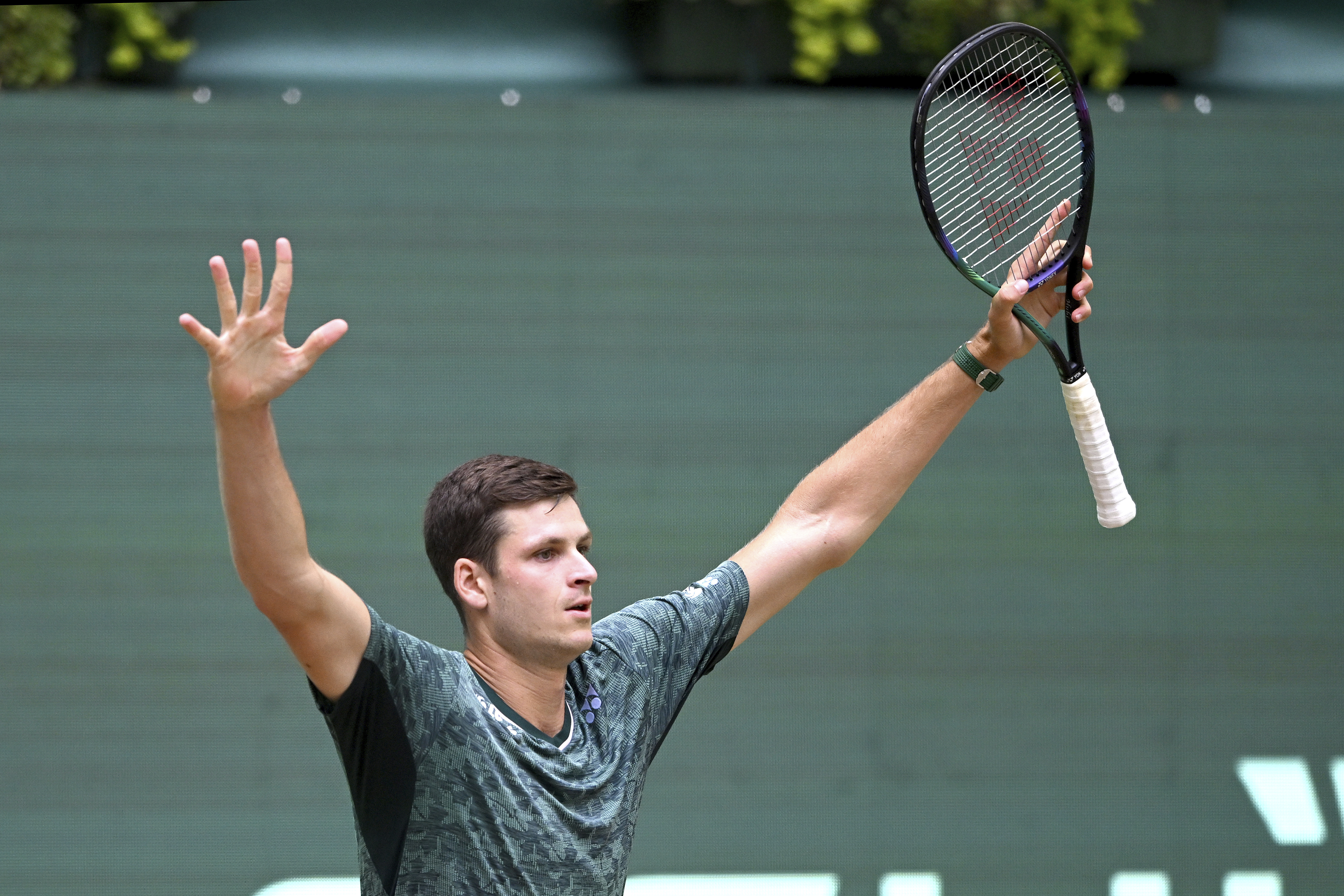Poland's Hubert Hurkacz celebrates defeating Australia's Nick Kyrgios in the ATP Tour men's singles semifinal match in Halle, Germany, Saturday June 18, 2022. (David Inderlied/dpa via AP)