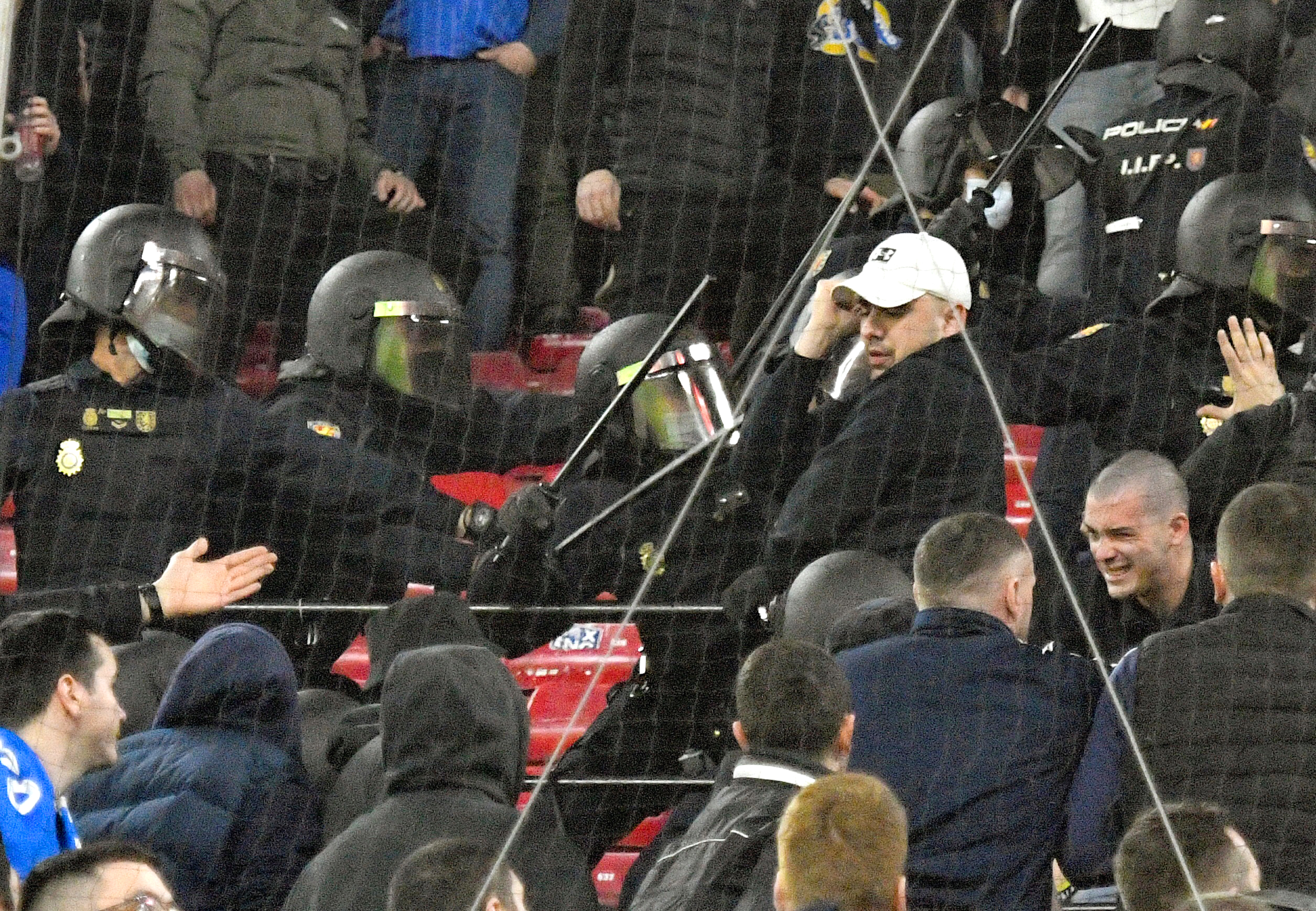 epa09767543 Dinamo Zagreb fans clash with Spanish National Police riot units during the UEFA Europa League playoff, first leg soccer match between Sevilla FC and Dinamo Zagreb in Seville, Spain, 17 February 2022.  EPA-EFE/Raul Caro