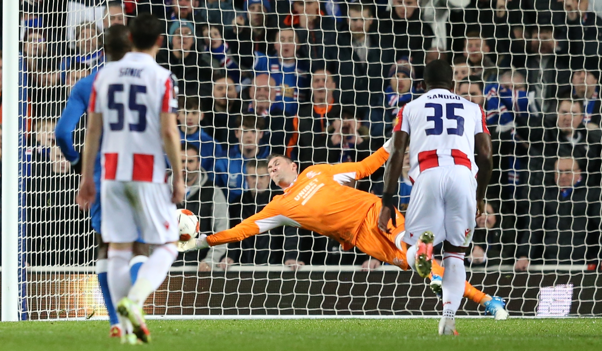 epa09815936 Rangers goalkeeper Allan McGregor (C) saves a penalty shot during the UEFA Europa League round of 16, first leg soccer match between Glasgow Rangers and Red Star Belgrade in Glasgow, Britain, 10 March 2022.  EPA-EFE/ROBERT PERRY
