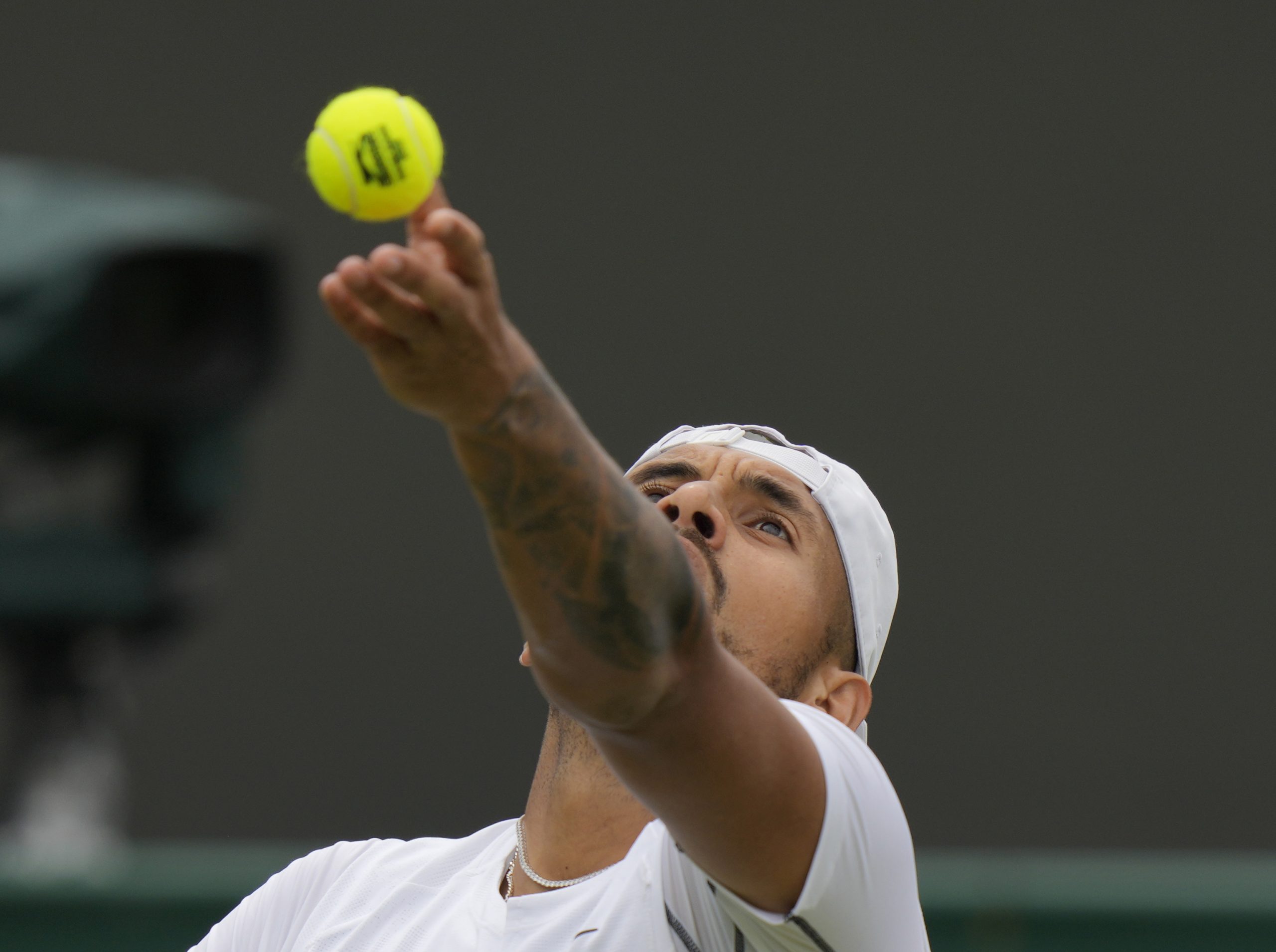 Australia's Nick Kyrgios serves to Serbia's Filip Krajinovic, in a second round men's single match on day four of the Wimbledon tennis championships in London, Thursday, June 30, 2022. (AP Photo/Alastair Grant)