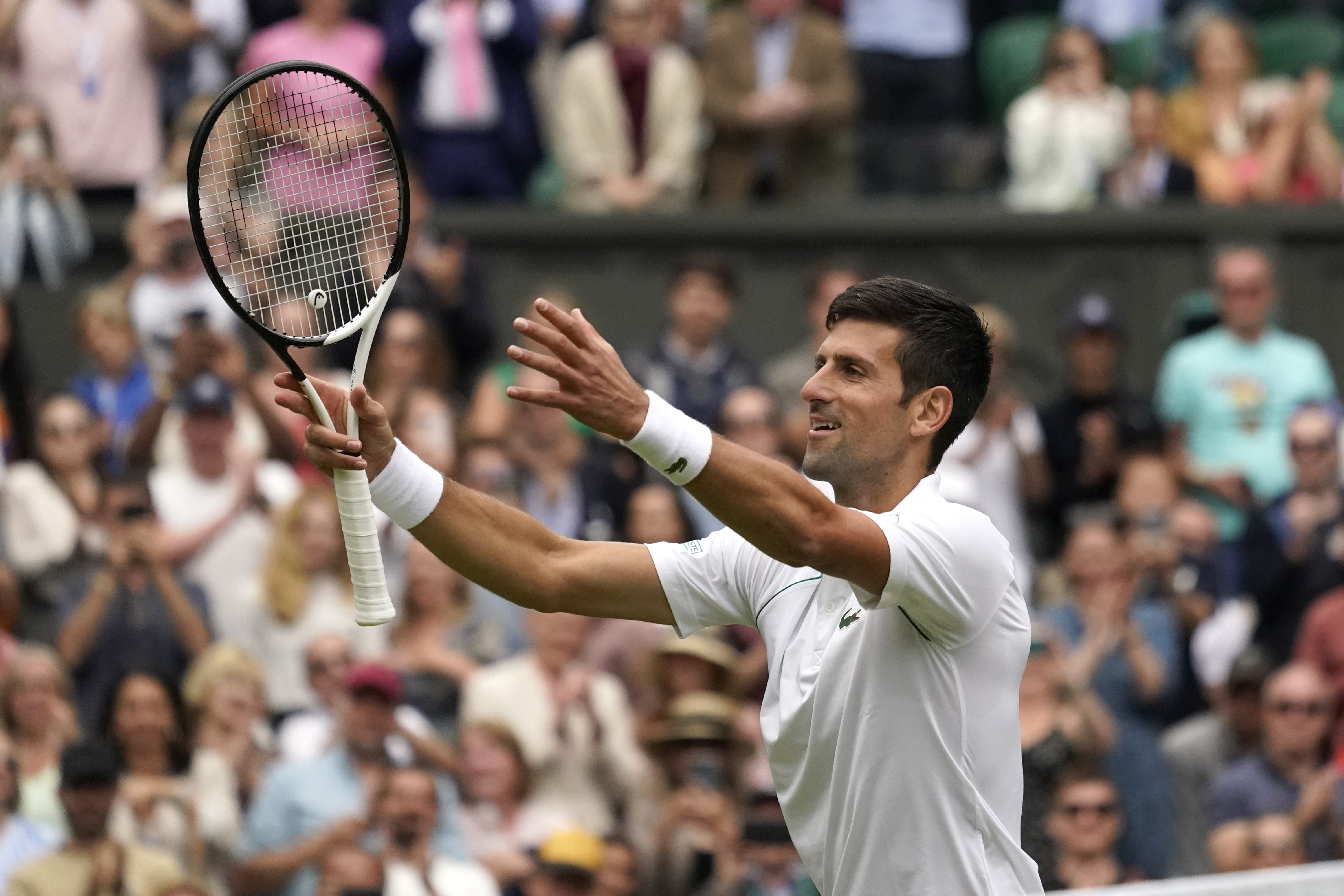 Serbia's Novak Djokovic celebrates defeating Serbia's Miomir Kecmanovic in a men's singles match on day five of the Wimbledon tennis championships in London, Friday, July 1, 2022. (AP Photo/Alberto Pezzali)
