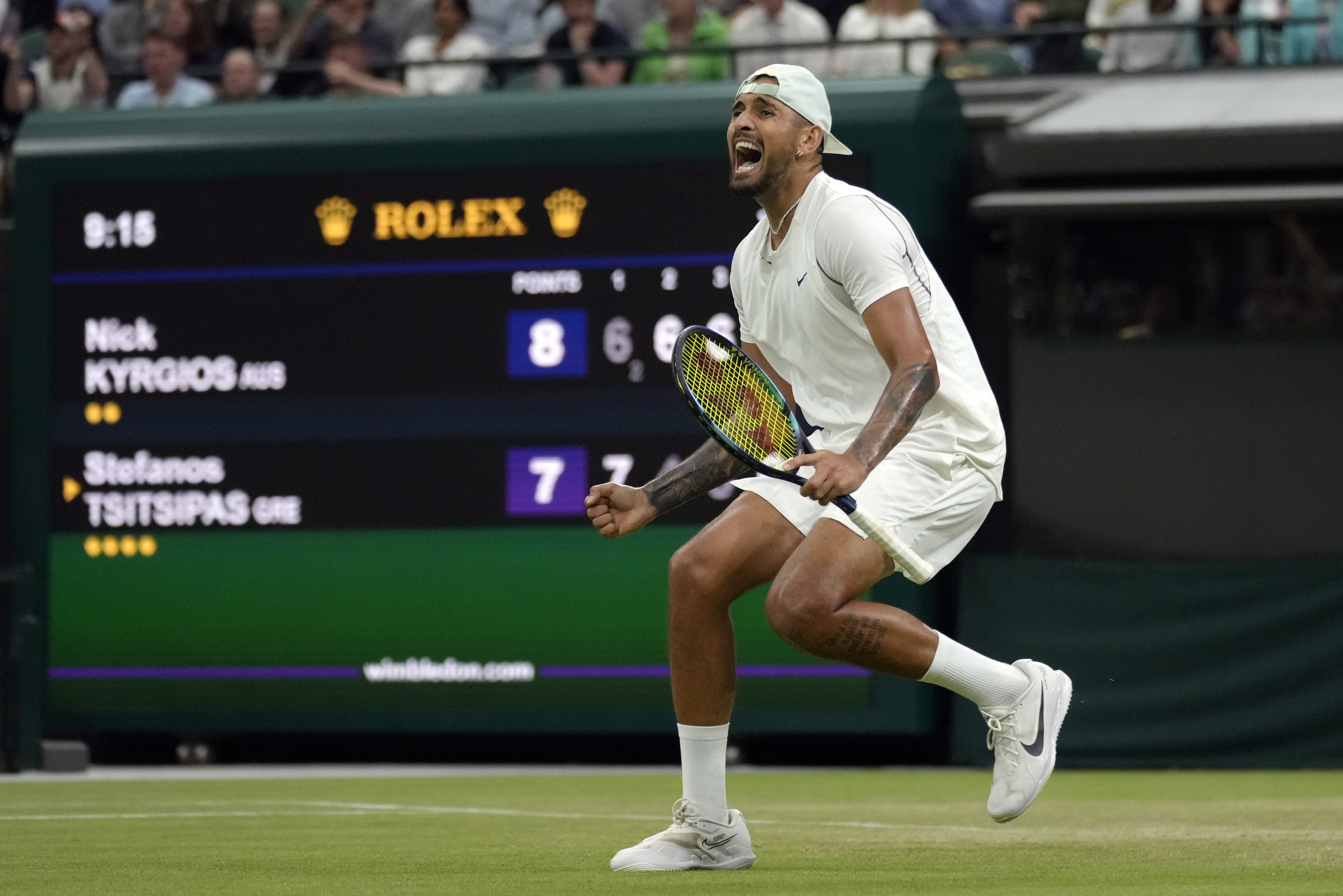 Australia's Nick Kyrgios celebrates beating Greece's Stefanos Tsitsipas during their third round men's singles match on day six of the Wimbledon tennis championships in London, Saturday, July 2, 2022. (AP Photo/Kirsty Wigglesworth)