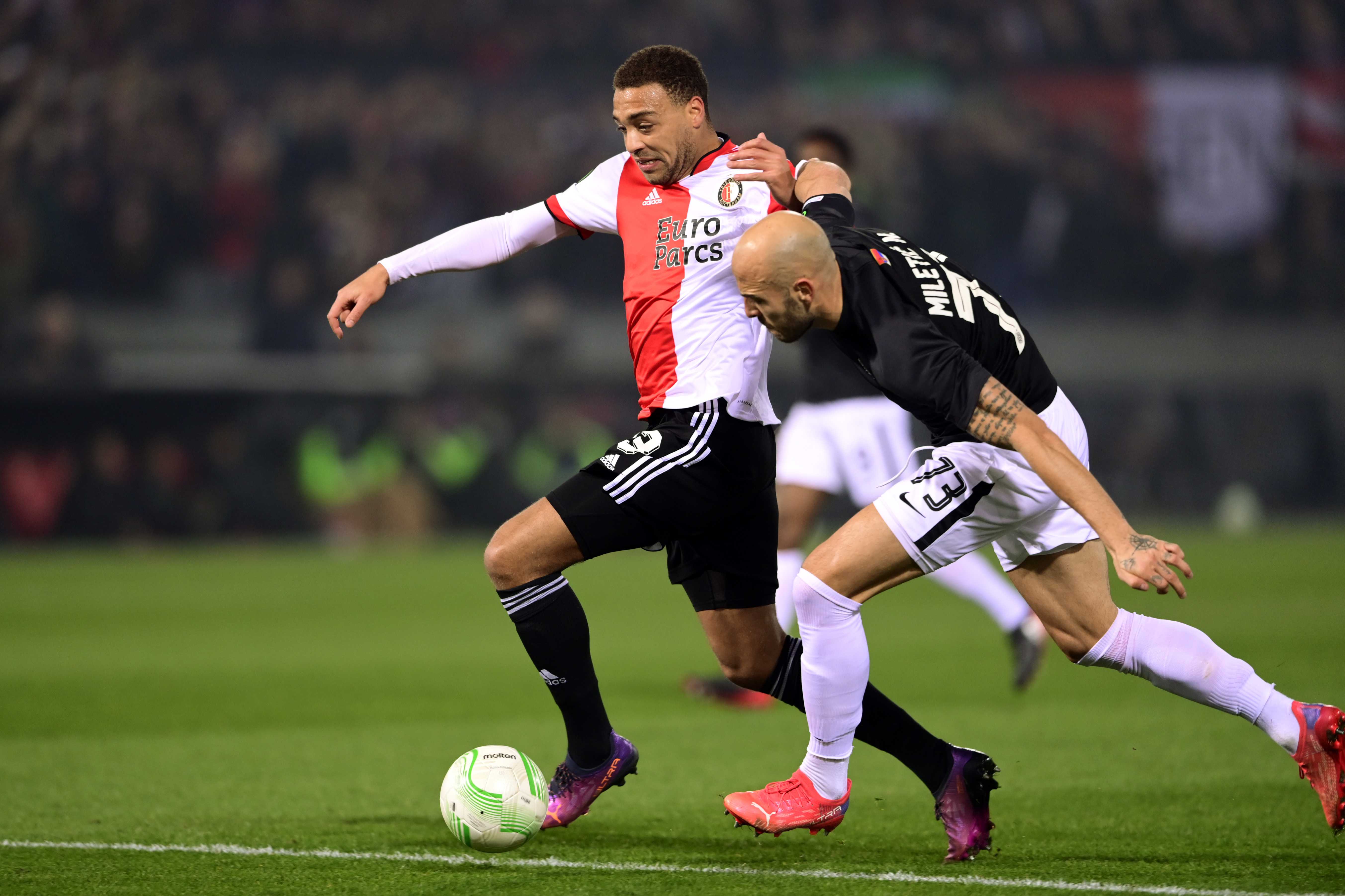 epa09832241 (L-R) Cyriel Dessers of Feyenoord, Nemanja Mileti? or FK Partizan during the Conference League match between Feyenoord and Partizan at Feyenoord Stadium de Kuip in Rotterdam, Netherlands, 17 March 2022.  EPA-EFE/OLAF KRAAK