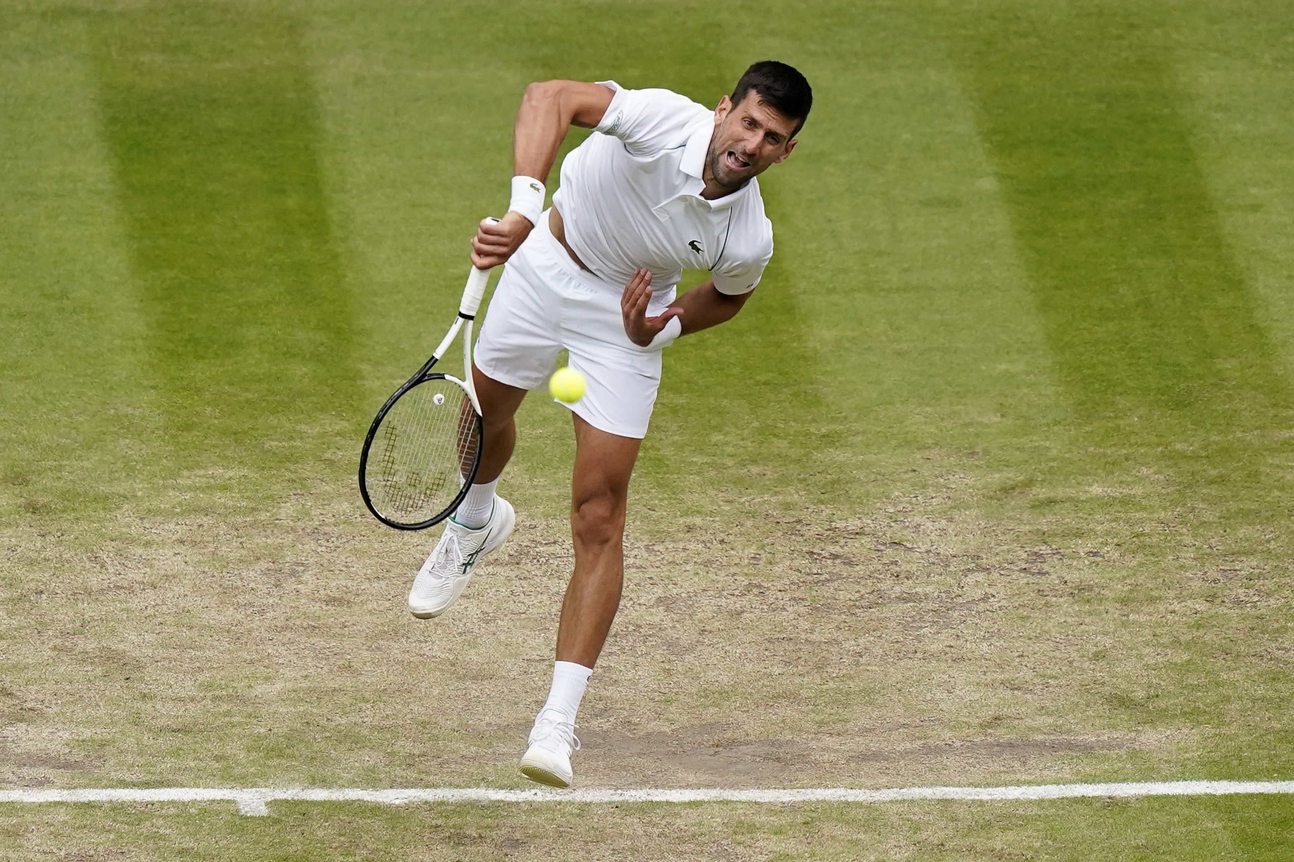 Serbia's Novak Djokovic serves to Italy's Jannik Sinner in a men's singles quarterfinal match on day nine of the Wimbledon tennis championships in London, Tuesday, July 5, 2022. (AP Photo/Alberto Pezzali)