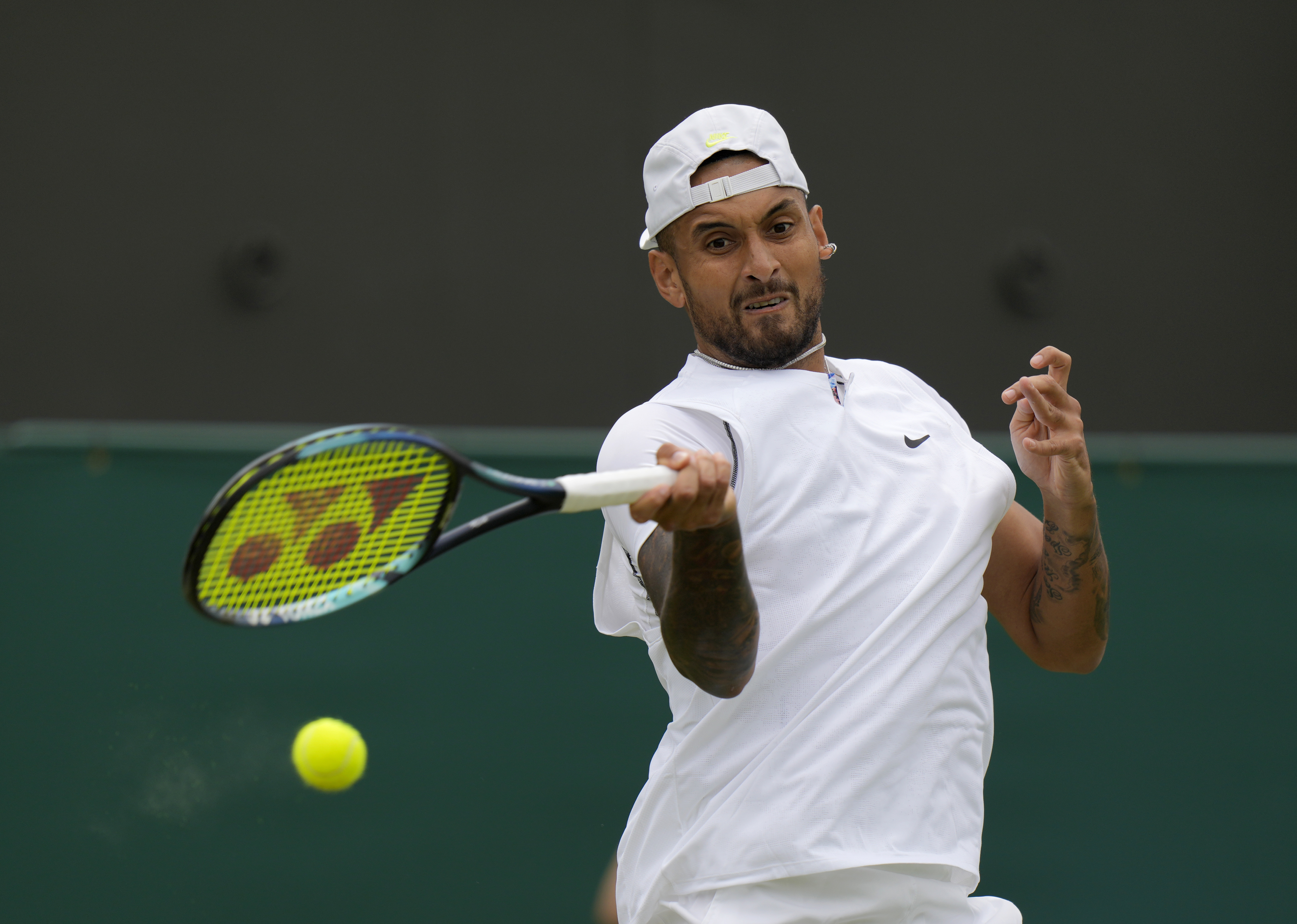 Australia's Nick Kyrgios returns to Serbia's Filip Krajinovic, in a second round men's single match on day four of the Wimbledon tennis championships in London, Thursday, June 30, 2022. (AP Photo/Alastair Grant)