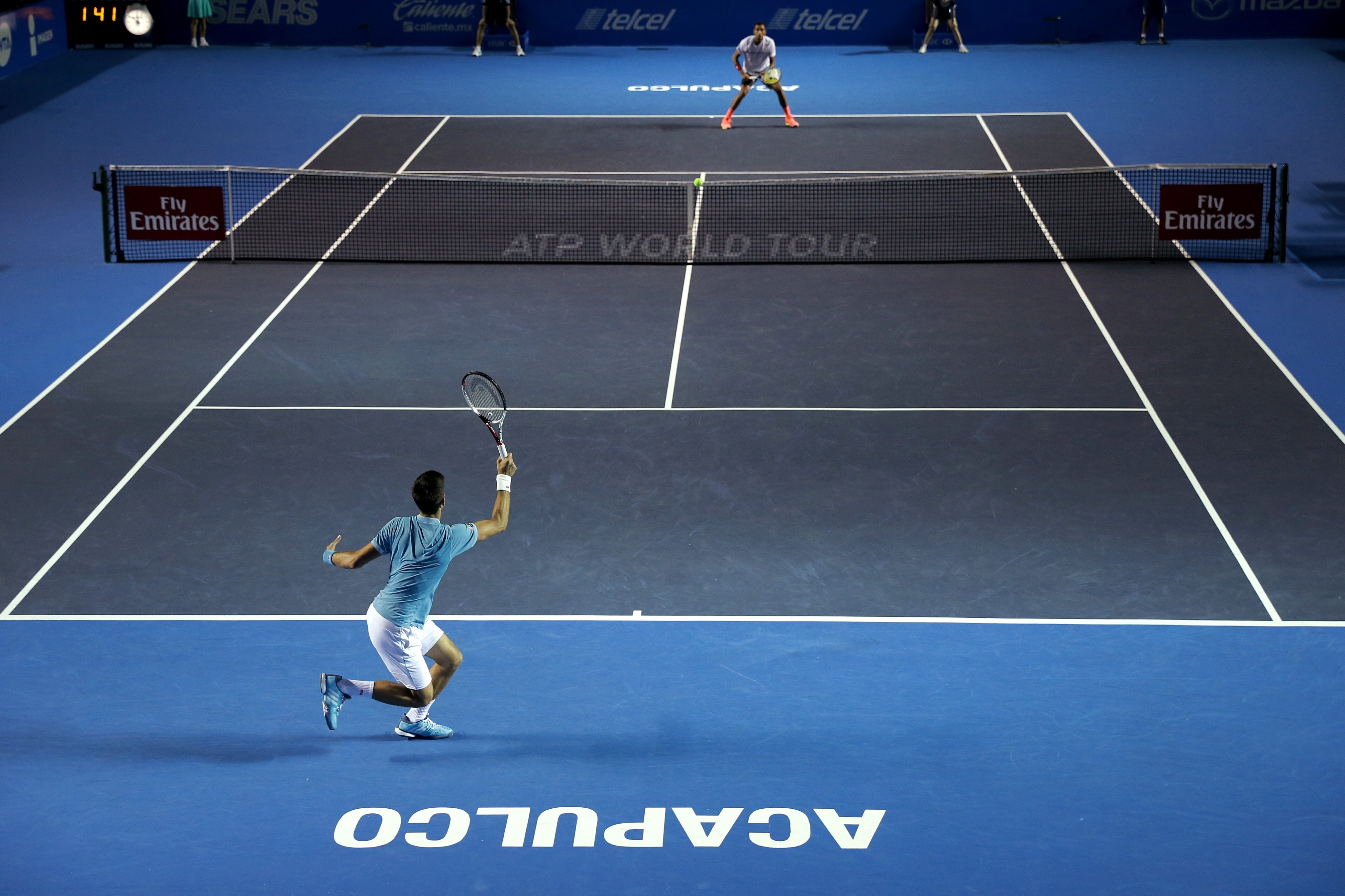 epa05826211 Novak Djokovic of Serbia (bottom) and Nick Kyrgios of Australia (top) during their Mexican Tennis Open Tournament quarter final game in Acapulco, Mexico, 02 March 2017.  EPA/JOSE MENDEZ