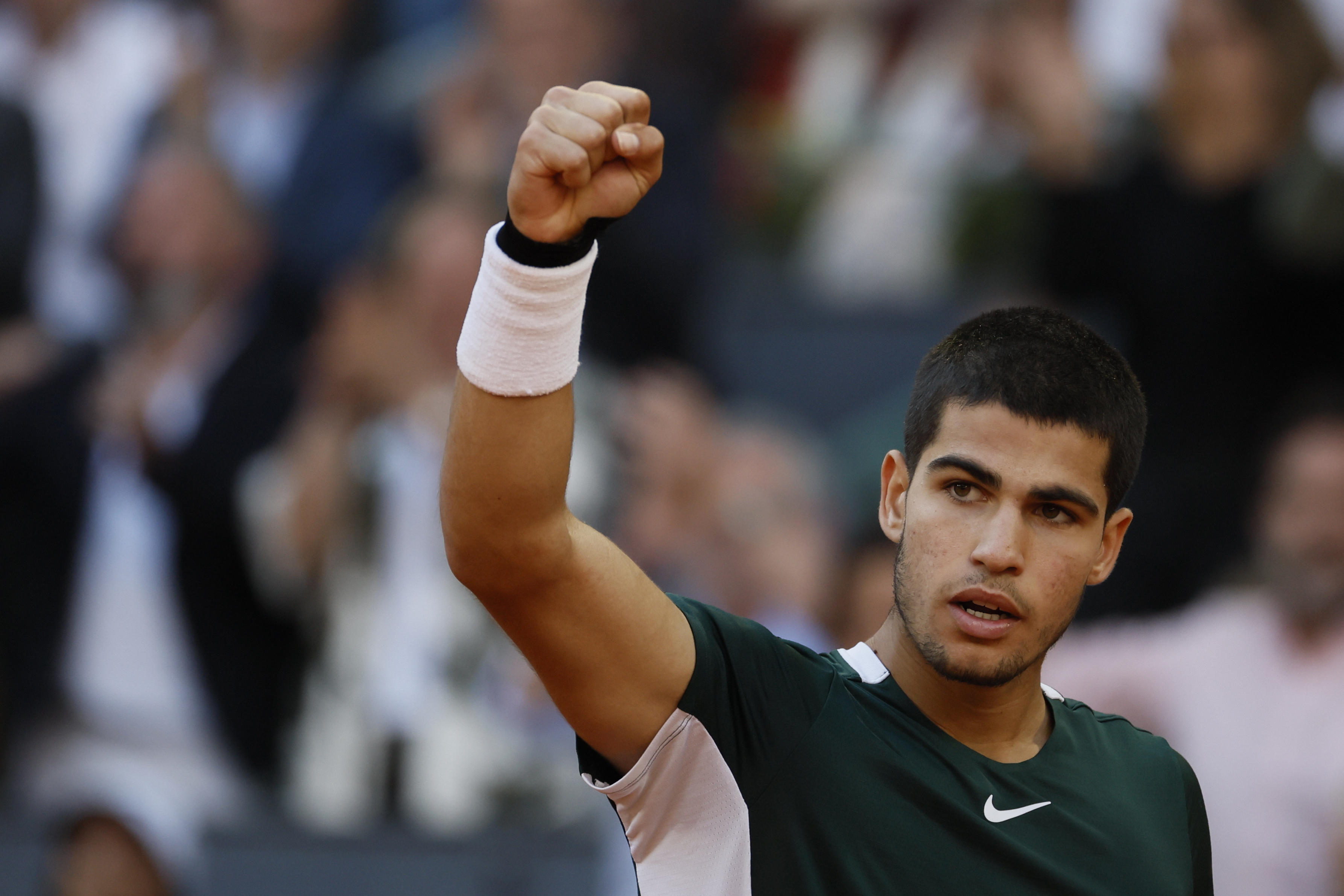 epa09932224 Carlos Alcaraz of Spain celebrates winning against Novak Djokovic of Serbia during their Mutua Madrid Open tennis tournament's semifinal match at Caja Magica sport complex in Madrid, Spain, 07 May 2022.  EPA-EFE/JUANJO MARTIN