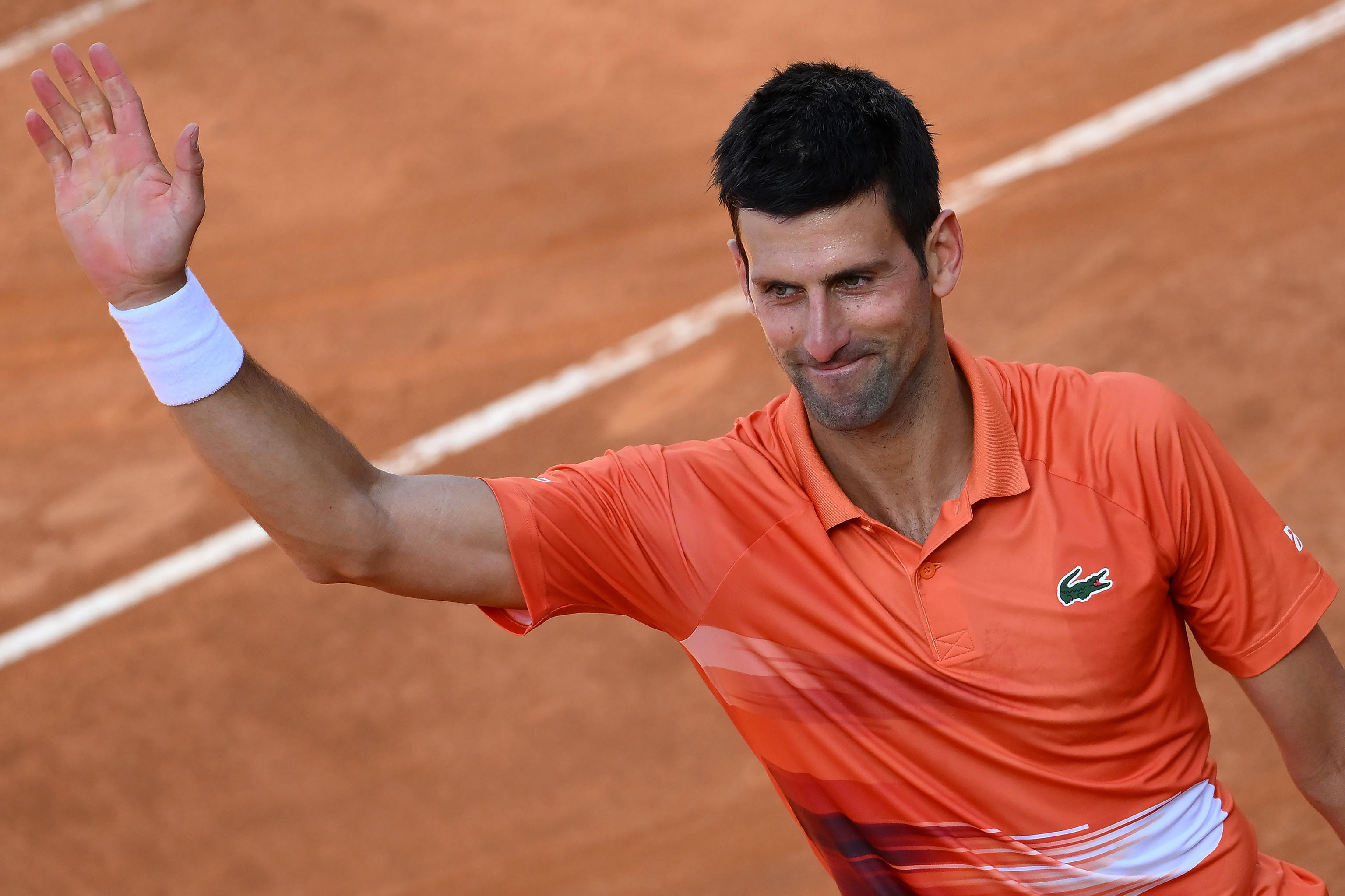 epa09938346 Novak Djokovic of Serbia celebrates after winning his men's singles second round match against Aslan Karatsev of Russia at the Italian Open tennis tournament in Rome, Italy, 10 May 2022.  EPA-EFE/ETTORE FERRARI