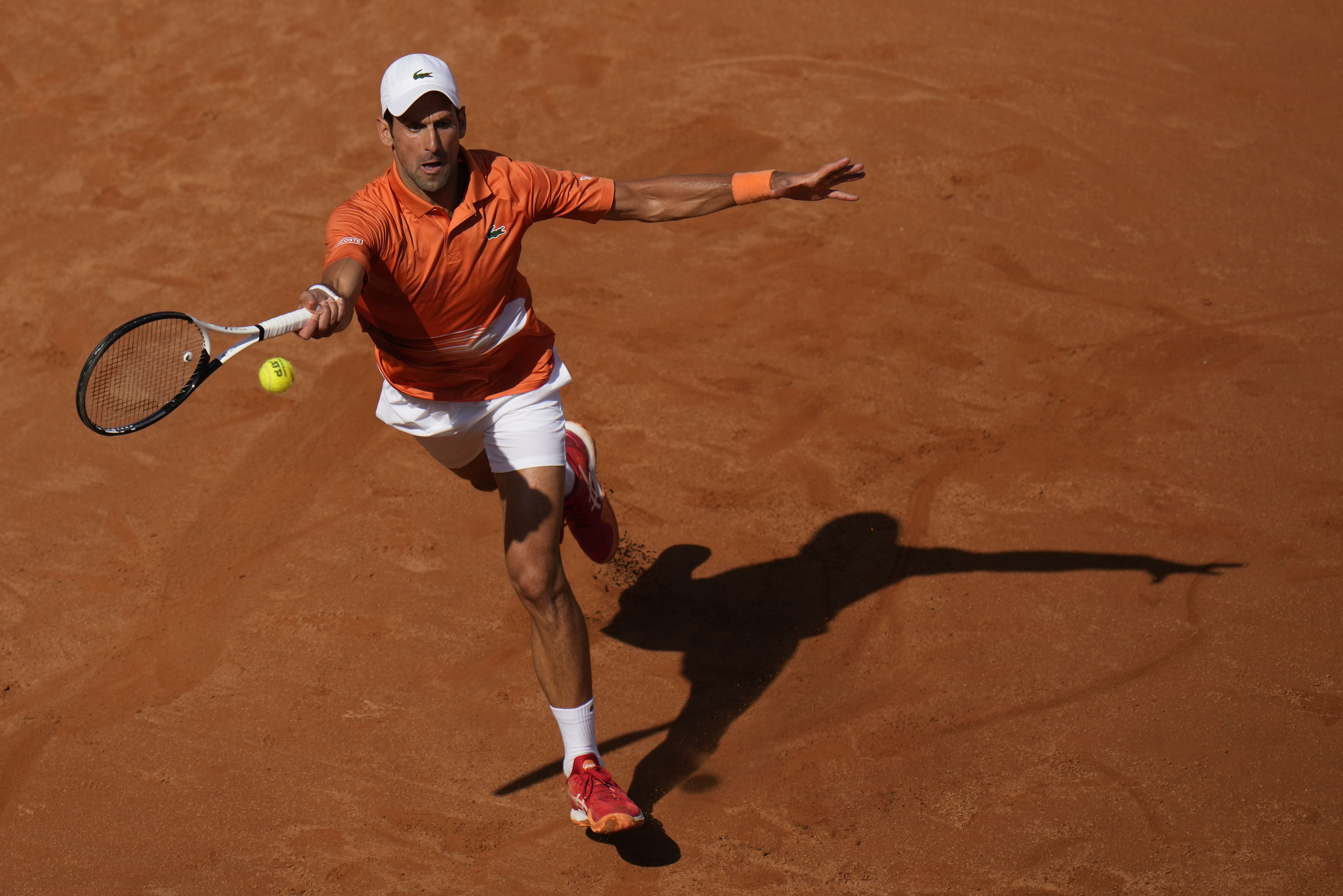 Serbia's Novak Djokovic returns the ball to Greece's Stefanos Tsitsipas during their final match at the Italian Open tennis tournament, in Rome, Sunday, May 15, 2022. (AP Photo/Alessandra Tarantino)