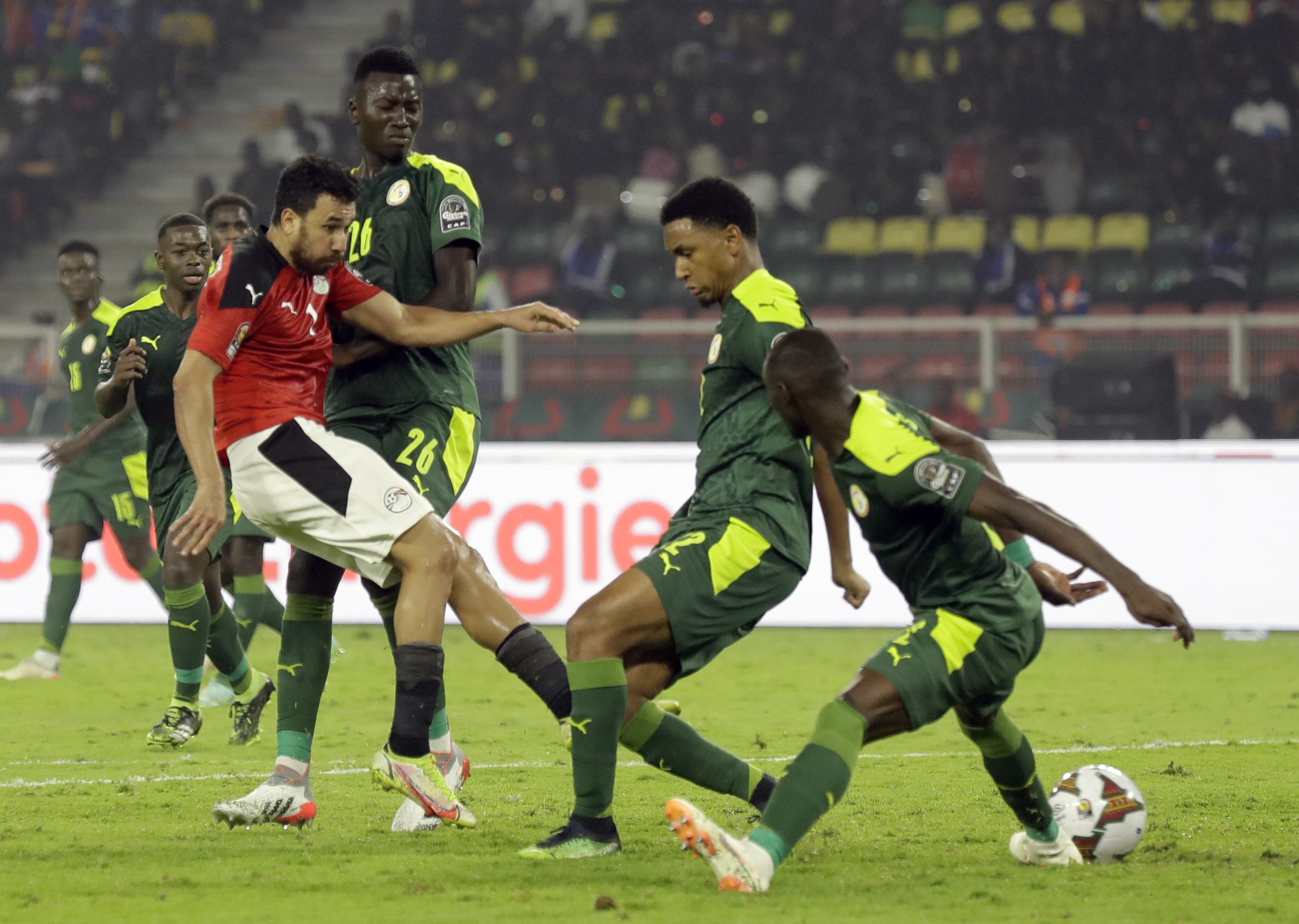 Egypt's Mahmoud Hassan Trezeguet, left, kicks the ball during the African Cup of Nations 2022 final soccer match between Senegal and Egypt at the Ahmadou Ahidjo stadium in Yaounde, Cameroon, Sunday, Feb. 6, 2022. (AP Photo/Sunday Alamba)