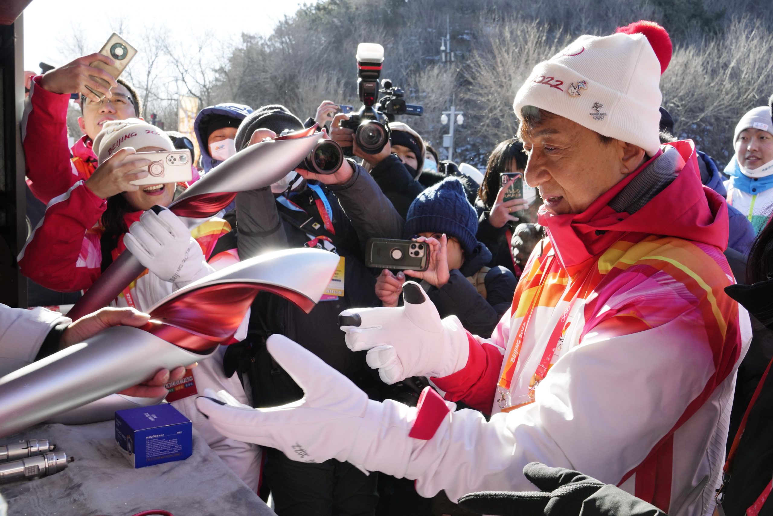 Hong Kong celebrity Jackie Chan receives the 2022 Winter Olympic torch as a souvenir after taking part in the torch relay at the Badaling Great Wall on the outskirts of Beijing, China, Thursday, Feb. 3, 2022. (AP Photo/Ng Han Guan)