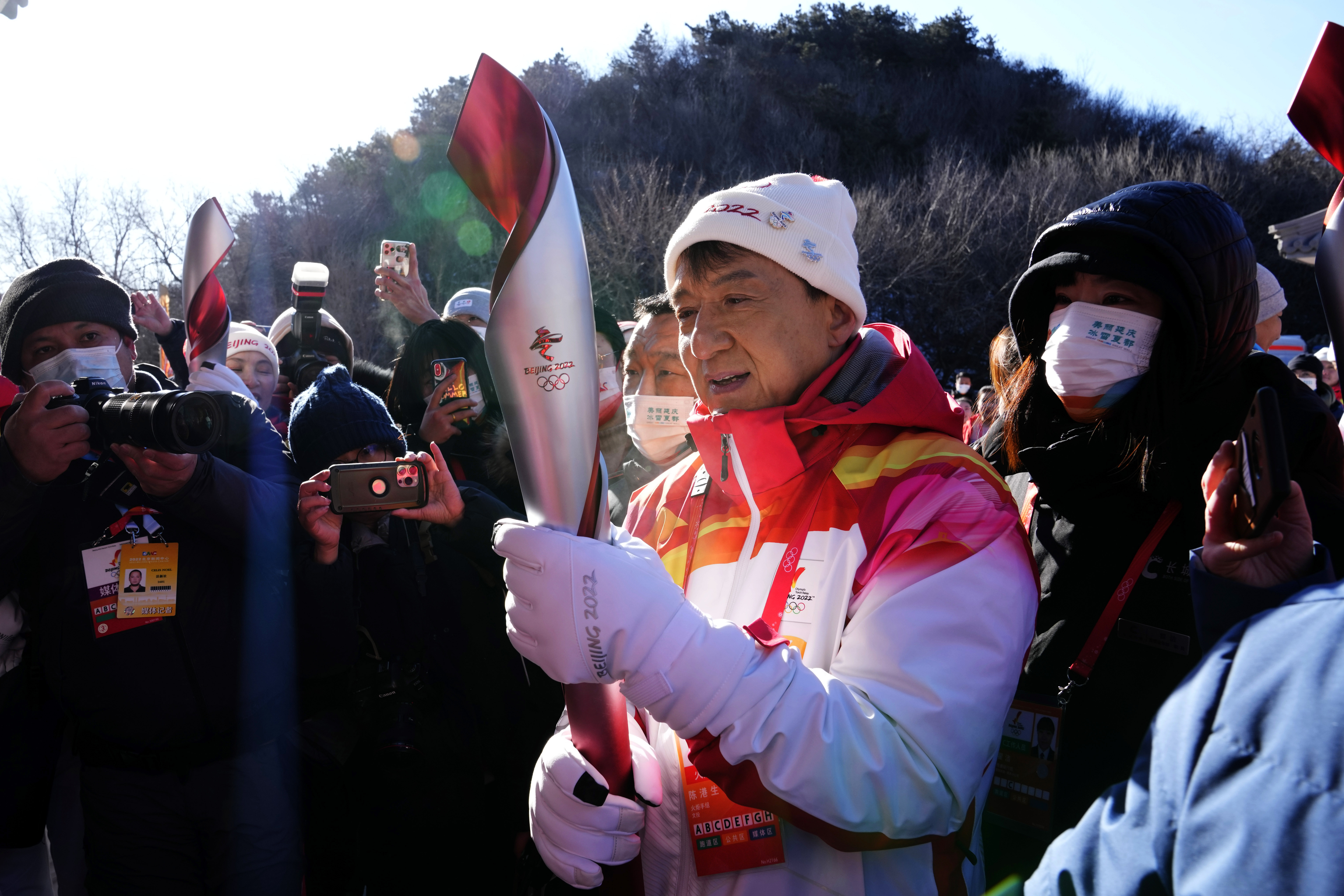 Hong Kong celebrity Jackie Chan holds the 2022 Winter Olympic torch after taking part in the torch relay at the Badaling Great Wall on the outskirts of Beijing, China, Thursday, Feb. 3, 2022. (AP Photo/Ng Han Guan)