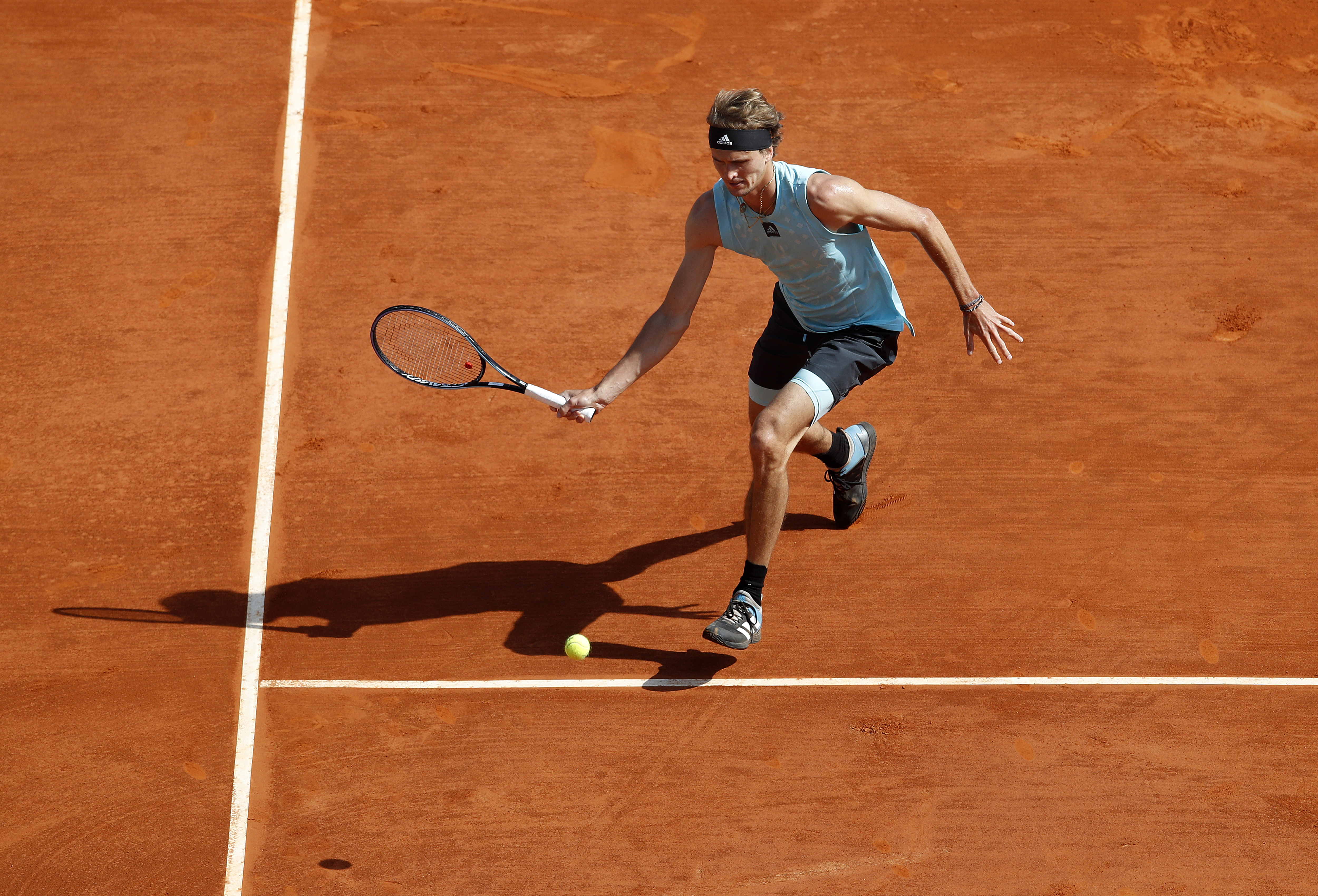 epa09889836 Alexander Zverev of Germany returns the ball to Pablo Carreno Busta of Spain during their third round match at the Monte-Carlo Rolex Masters tournament in Roquebrune Cap Martin, France, 14 April 2022.  EPA-EFE/SEBASTIEN NOGIER