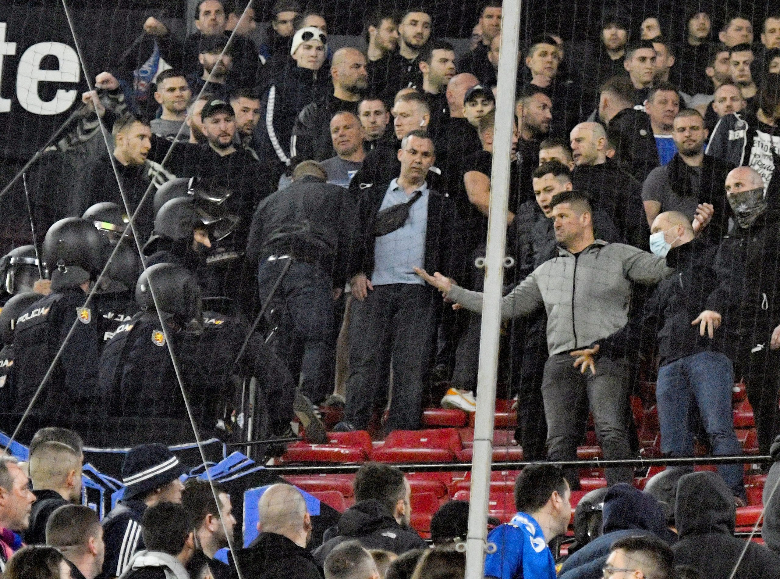 epa09767542 Dinamo Zagreb fans argue with Spanish National Police riot units during the UEFA Europa League playoff, first leg soccer match between Sevilla FC and Dinamo Zagreb in Seville, Spain, 17 February 2022.  EPA-EFE/Raul Caro