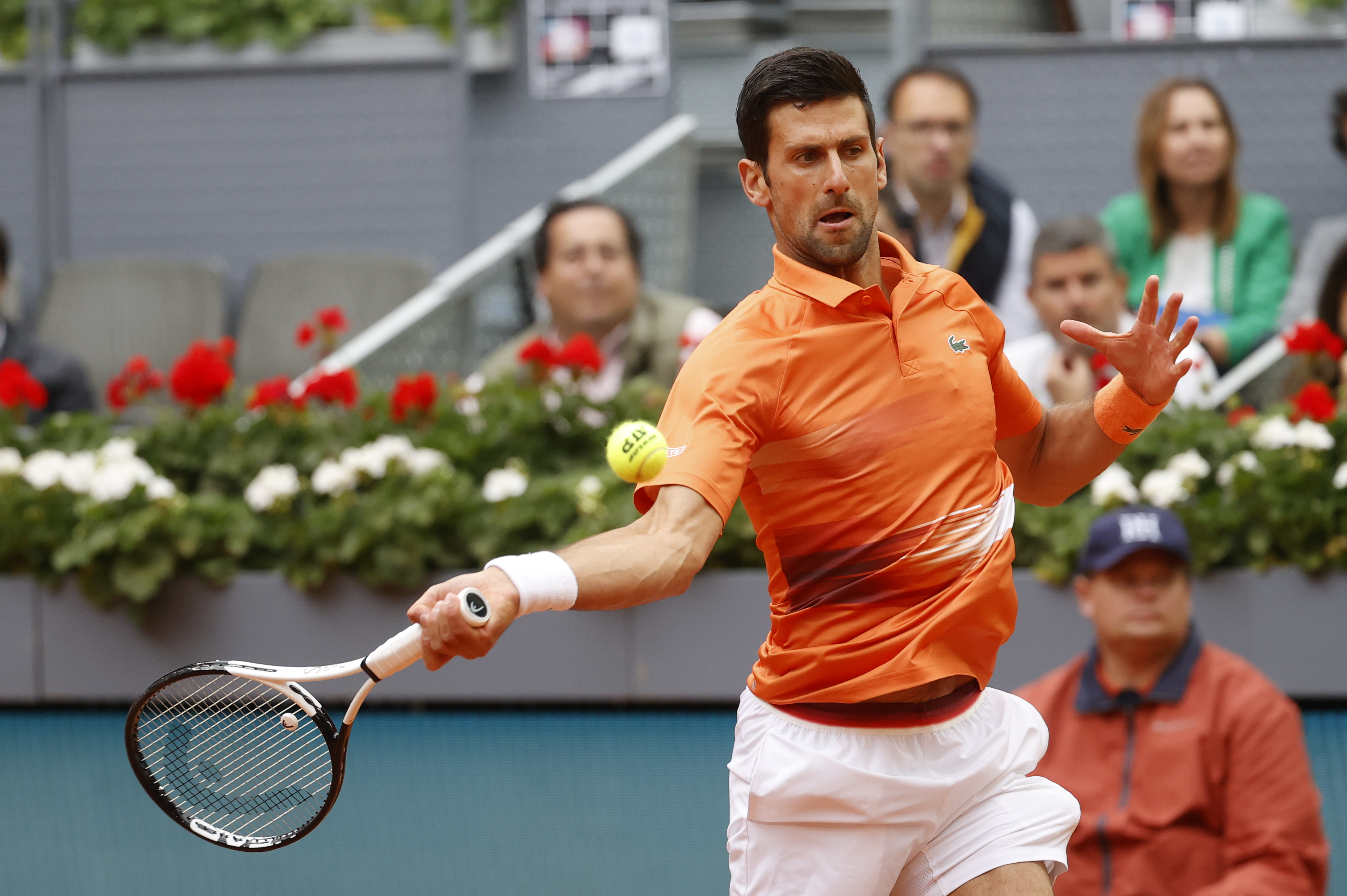 epa09924758 Serbia's tennis player Novak Djokovic in action against France's Gael Monfils during their Mutua Madrid Open's men's round of 32 match at the Caja Magica in Madrid, Spain, 03 May 2022.  EPA-EFE/Juanjo Martin