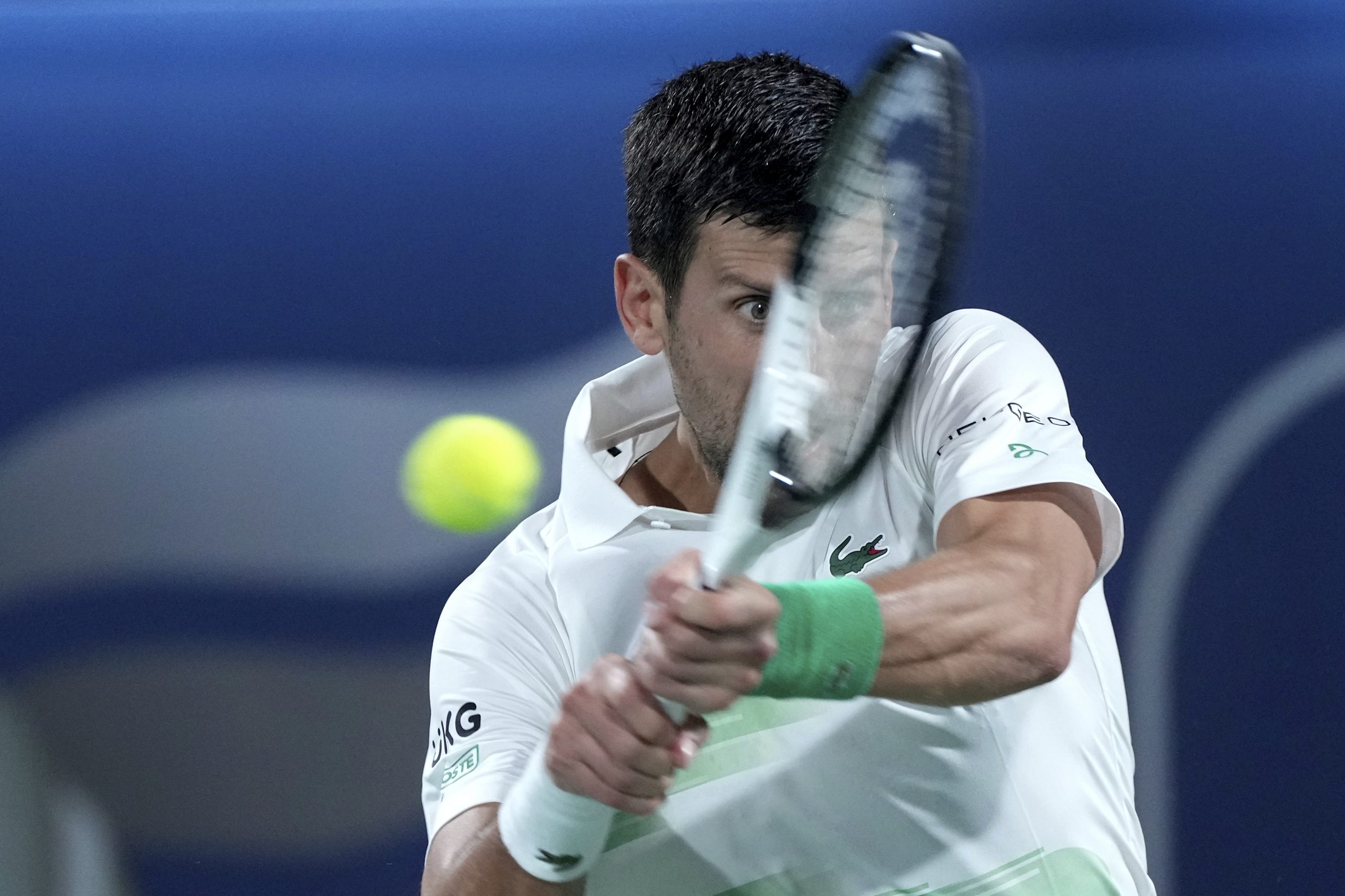 Serbia's Novak Djokovic returns the ball to Russia's Karen Khachanov during a match at the Dubai Duty Free Tennis Championship in Dubai, United Arab Emirates, Wednesday, Feb. 23, 2022. (AP Photo/Ebrahim Noroozi)