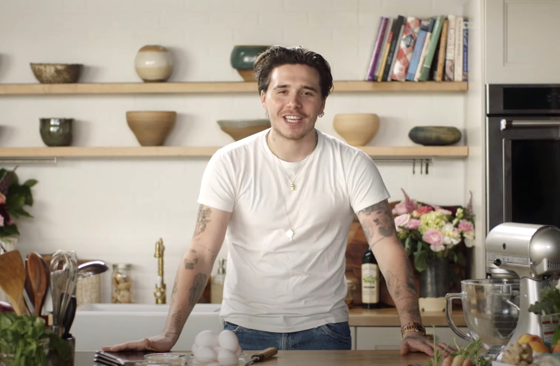 Brooklyn Beckham shows off his cooking skills by making Valentine's meal with his fiancée Nicola Peltz for Vogue.