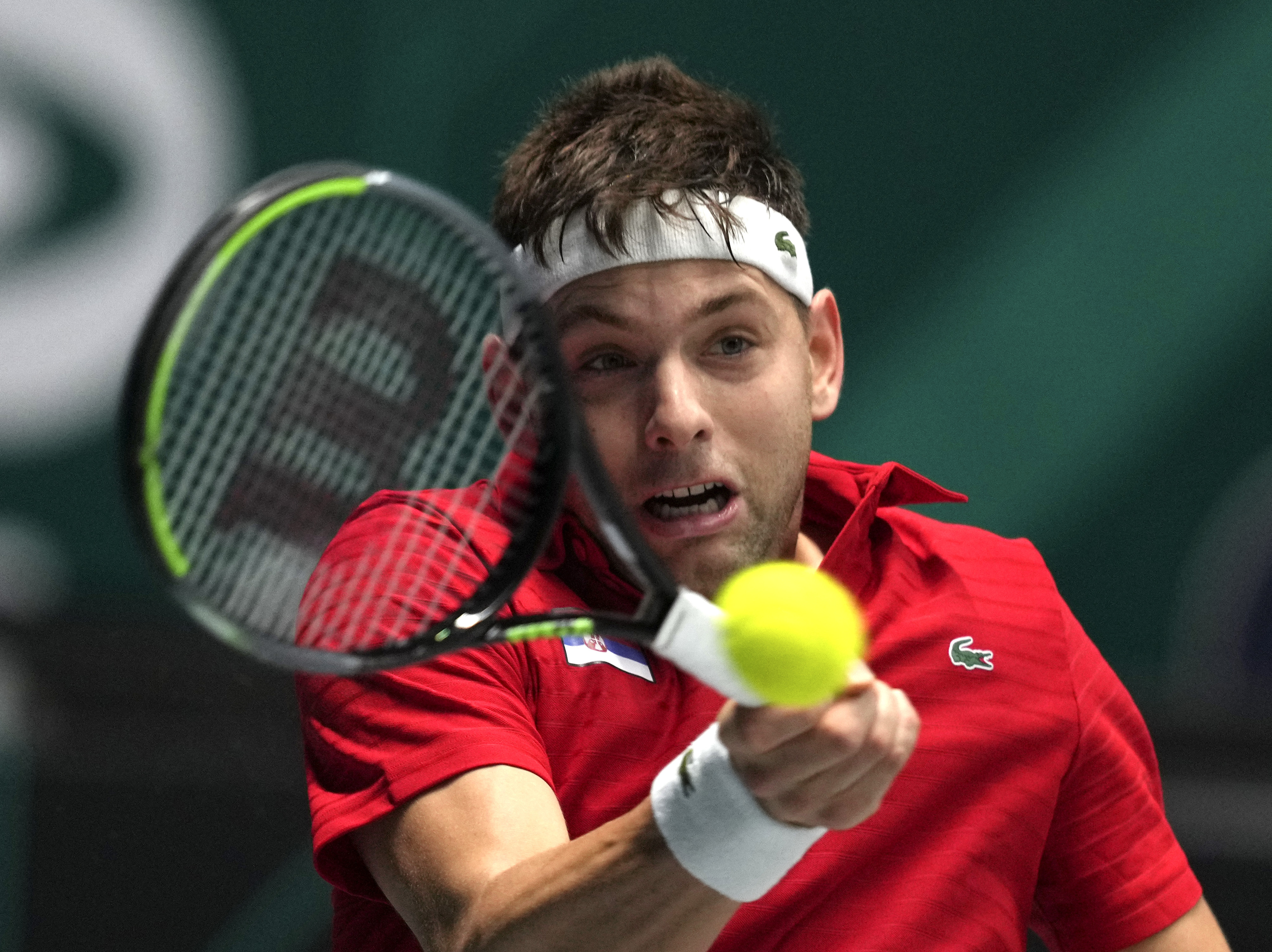 Filip Krajinovic of Serbia hits a forehand against Germany's Dominik Koepfer during a Davis Cup group F match between Serbia and Germany in Innsbruck, Austria, Saturday, Nov. 27, 2021. (Photo/Michael Probst)