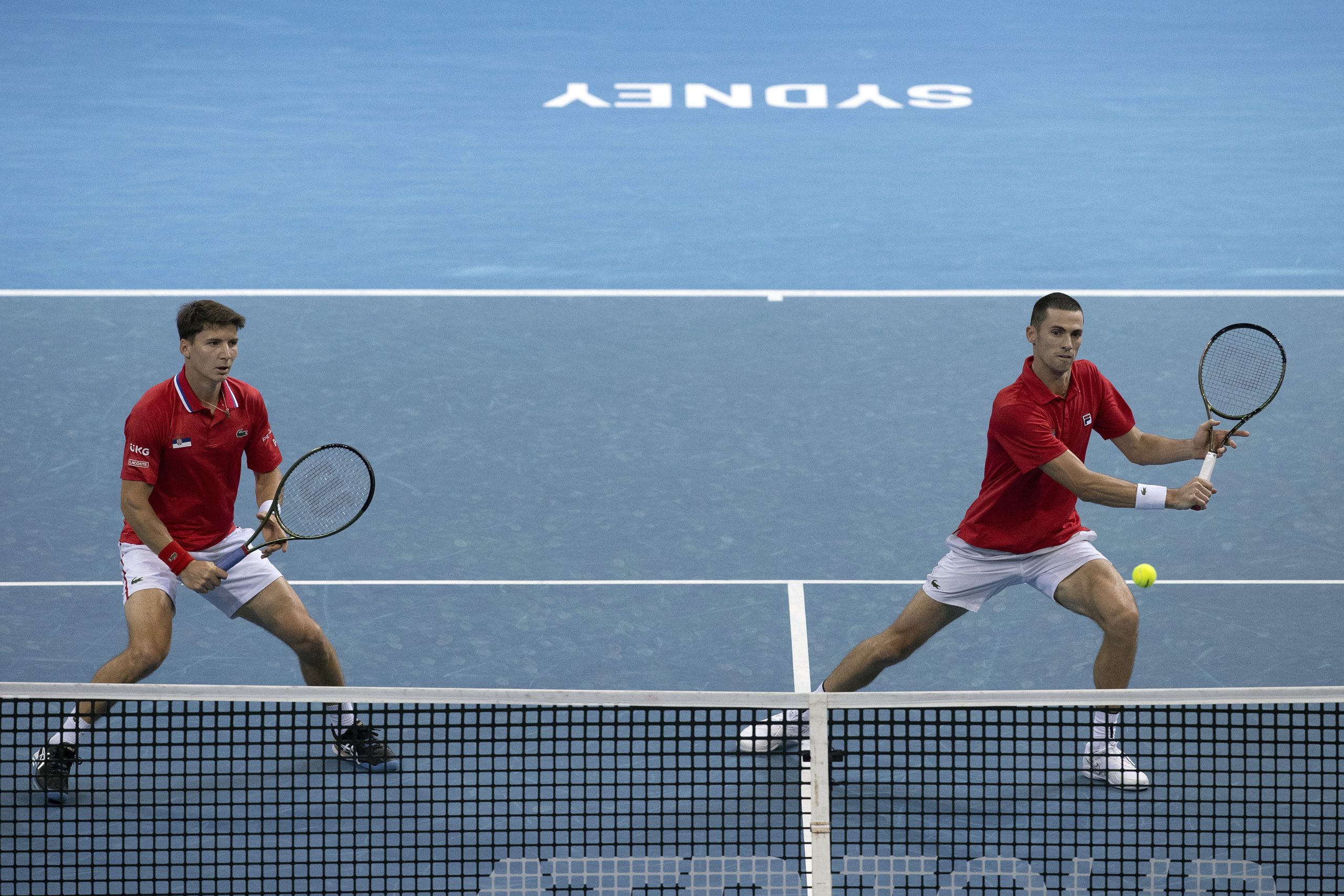 Nikola Cacic, right, and Matej Sabanov of Serbia play a shot against Chile's Tomas Barrios Vera and Alejandro Tabiloduring their doubles match at the ATP Cup tennis tournament in Sydney, Monday, Jan. 3, 2022. (AP Photo/Steve Christo)