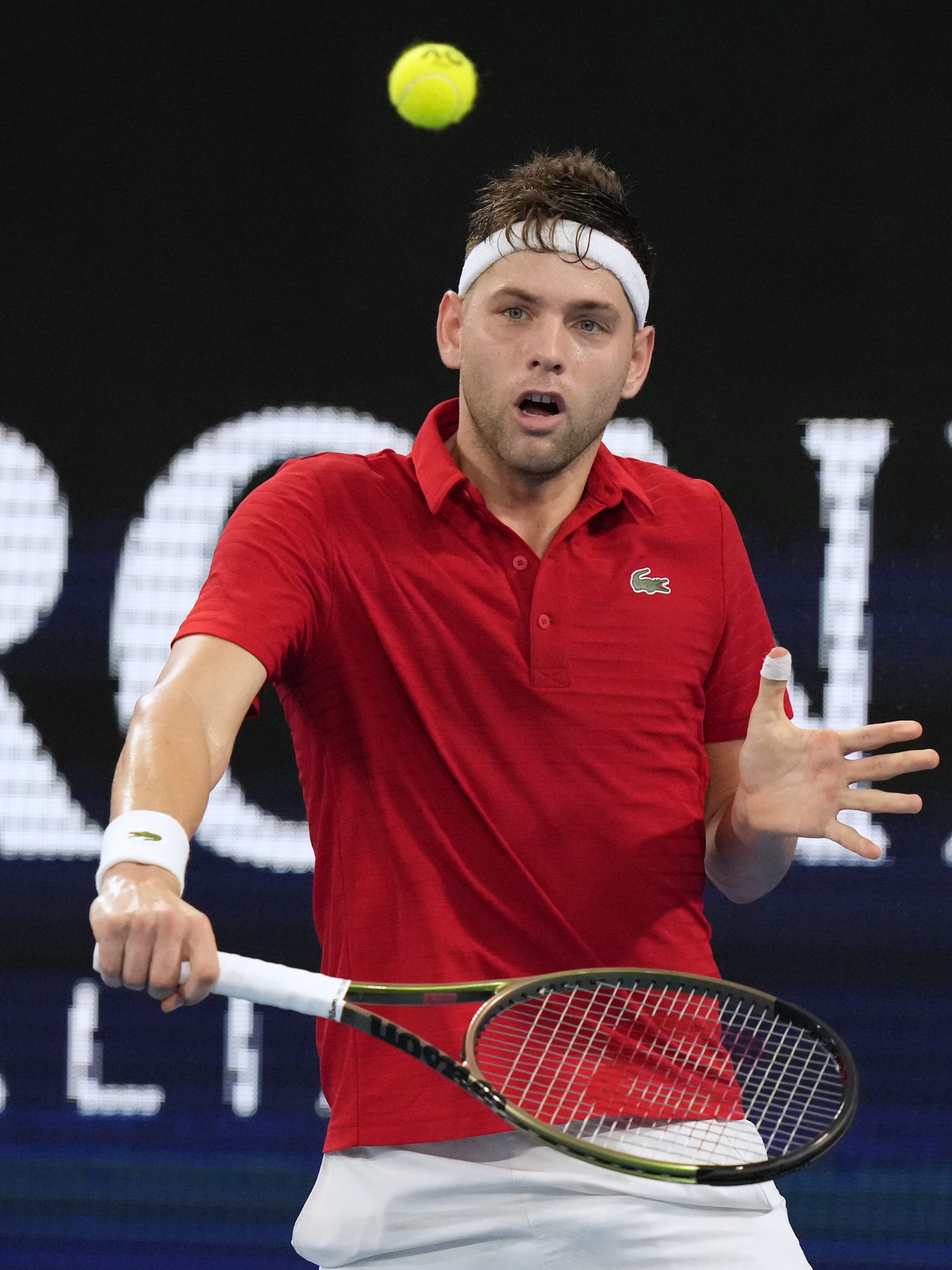Serbia's Filip Krajinovic lobs a ball to Norway's Viktor Durasovic during their match at the ATP Cup tennis tournament in Sydney, Saturday, Jan. 1, 2022. (AP Photo/Rick Rycroft)