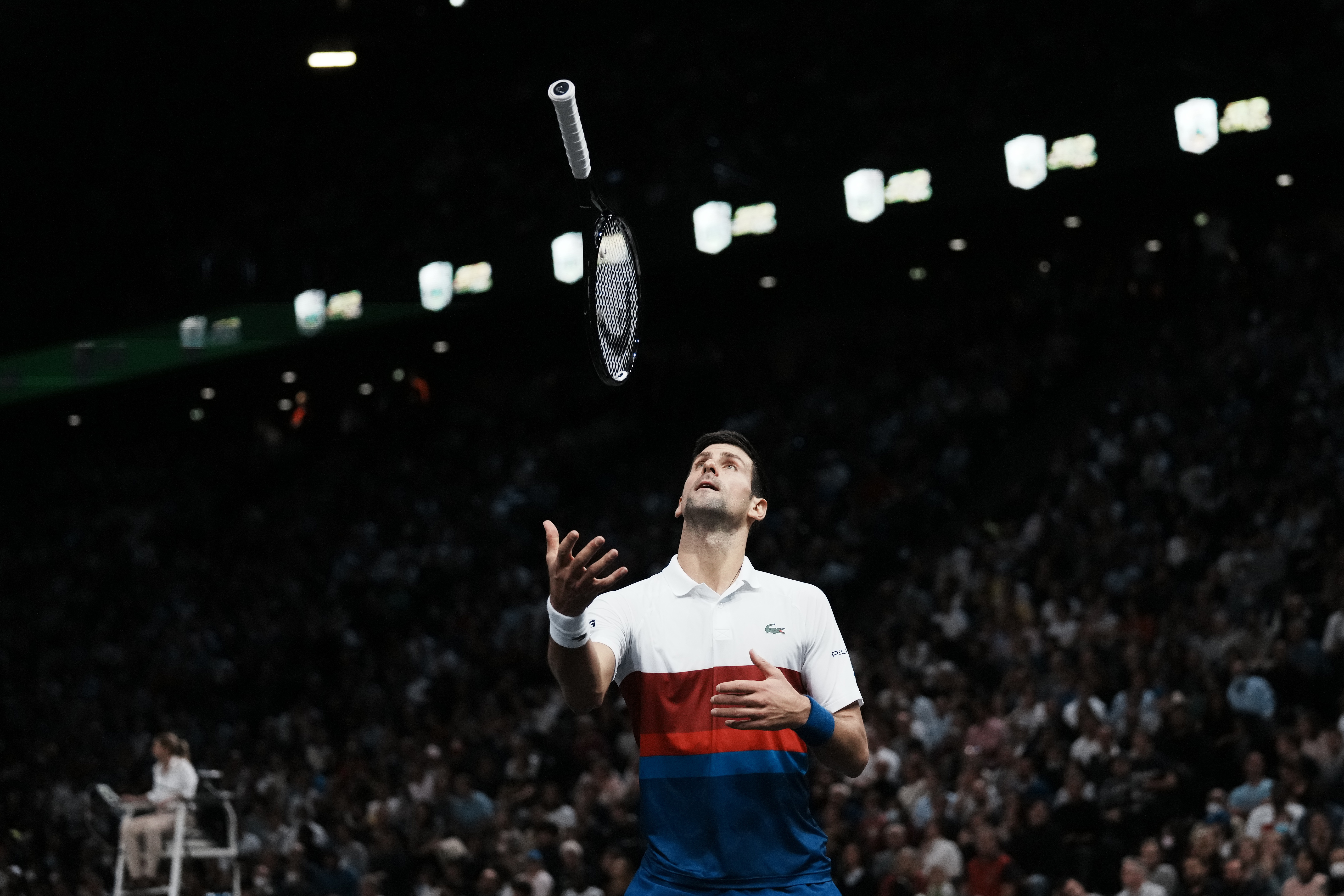 Serbia's Novak Djokovic throws his racket as he plays Russia's Daniil Medvedev during the final match of the Paris Masters tennis tournament at the Accor Arena in Paris, Sunday, Nov.7, 2021. (AP Photo/Thibault Camus)