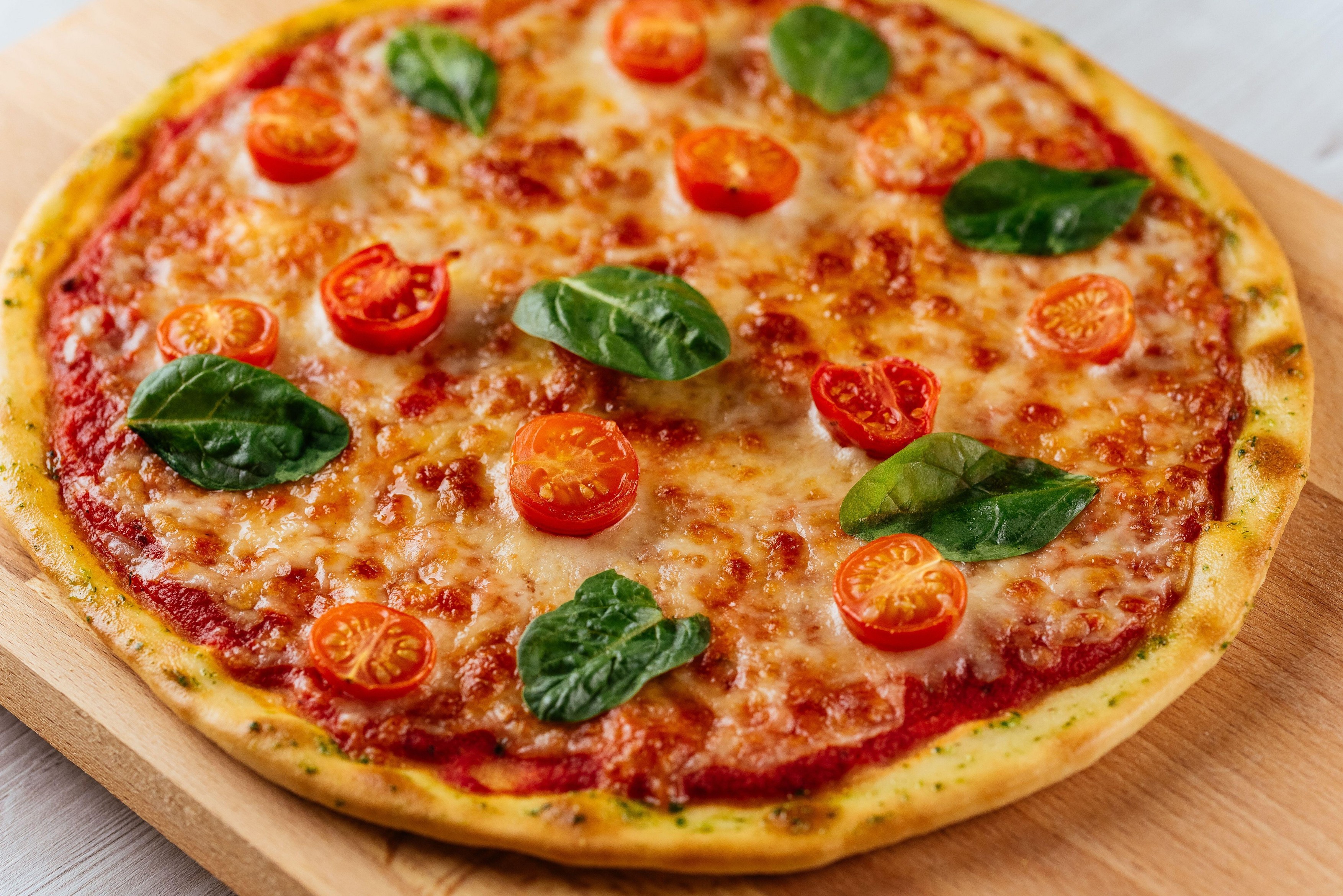 Italian pizza on a wooden Board and light background