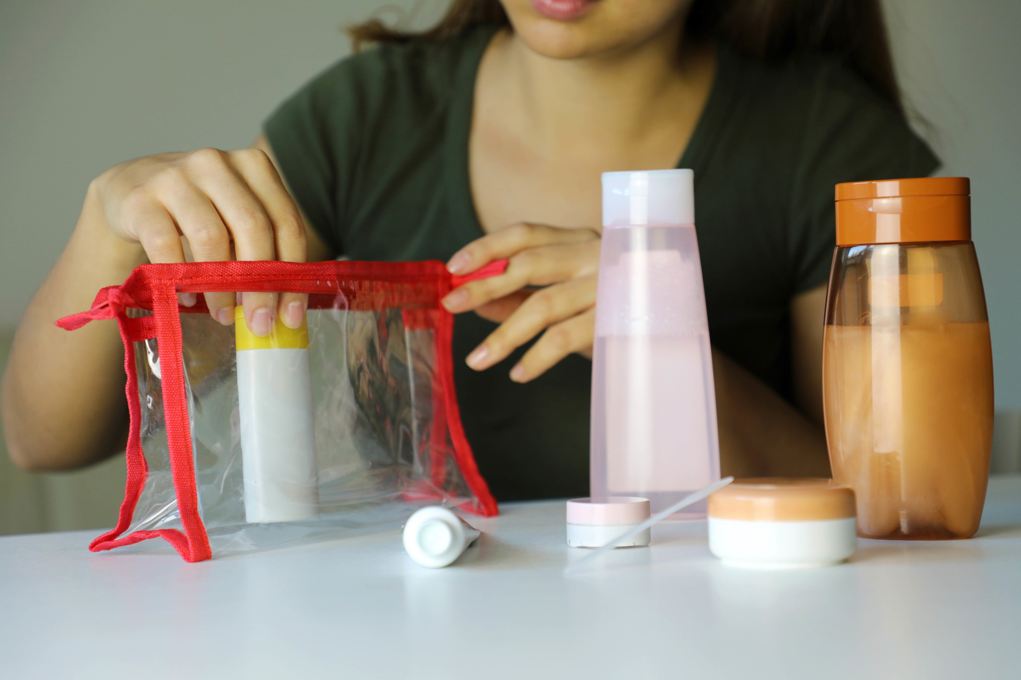 Woman preparing travel kit for transporting cosmetics on airplane,Image: 493747715, License: Royalty-free, Restrictions: , Model Release: yes, Credit line: Sergio Monti / Panthermedia / Profimedia