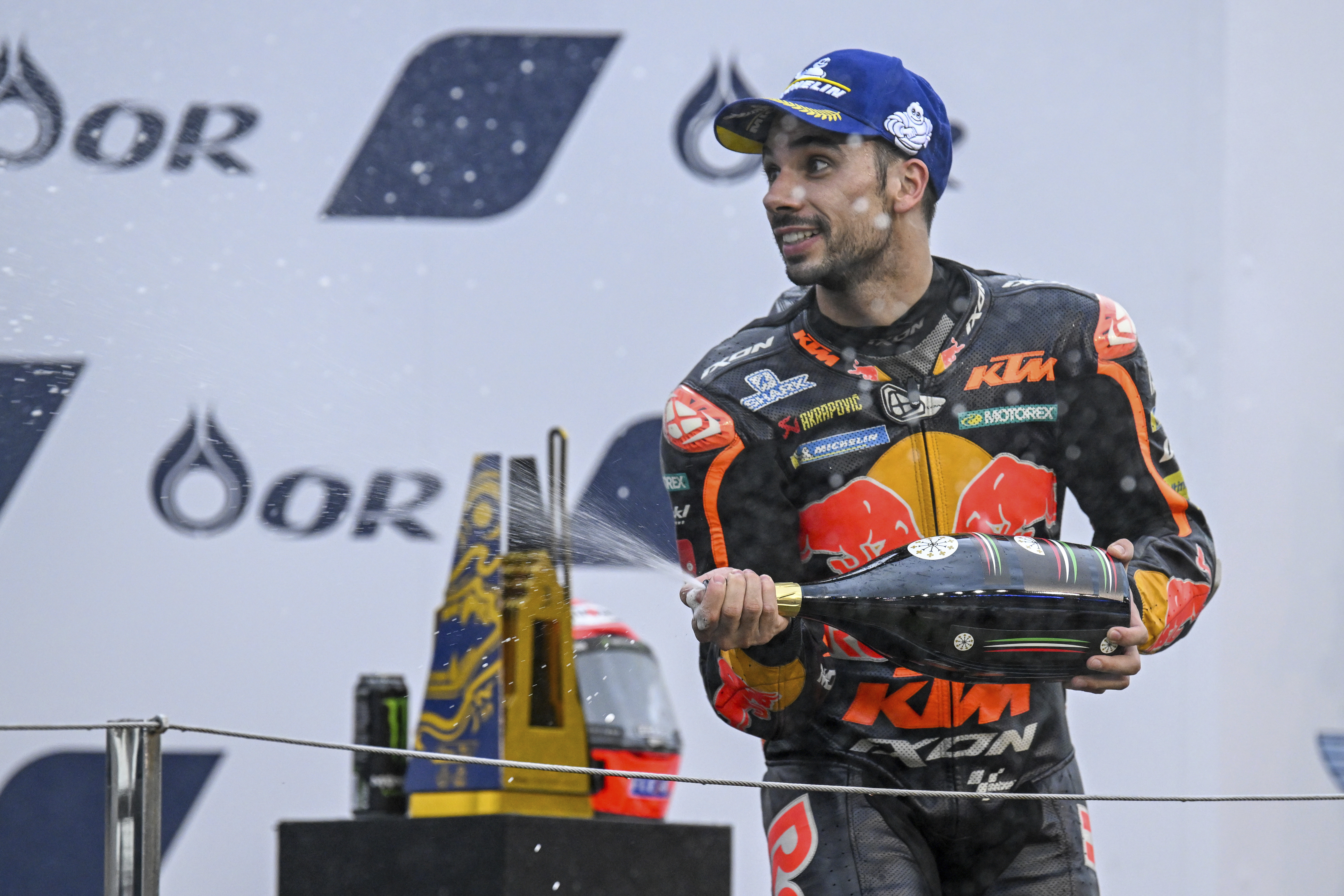 Portugal's rider Miguel Oliveira celebrates during the awards ceremony after winning the MotoGP at the Chang International Circuit in Buriram, Thailand, Sunday, Oct. 2, 2022. (Kittinun Rodsupan)