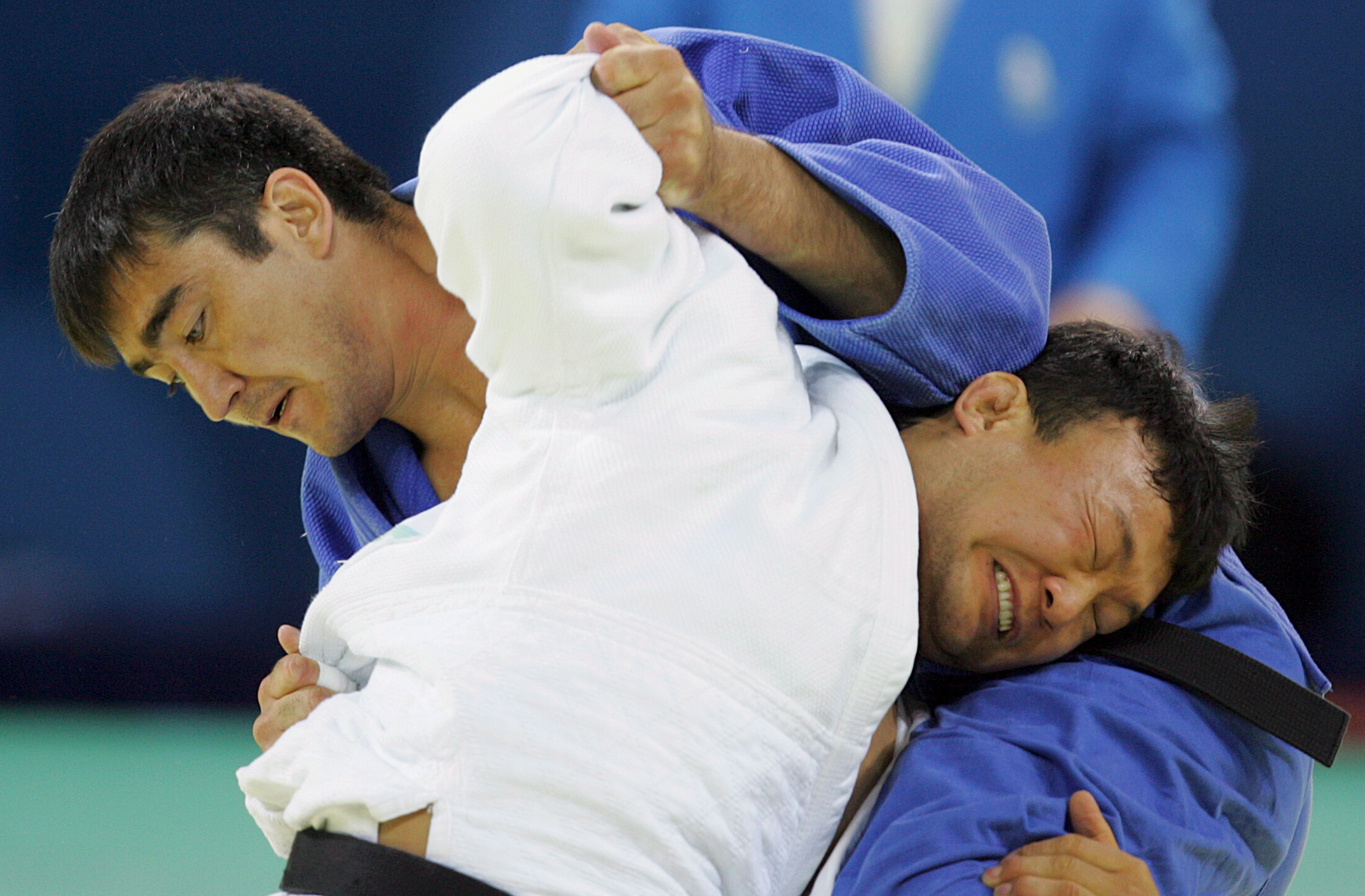 epa01446074 Tuvshinbayar Naidan (white) of Mongolia competes against Askhat Zhitkeyev of Kazakhstan in the men's 100kg category gold medal bout of the Judo events at the Beijing 2008 Olympic Games, Beijing, China, 14 August 2008.  EPA/SIMELA PANTZARTZI