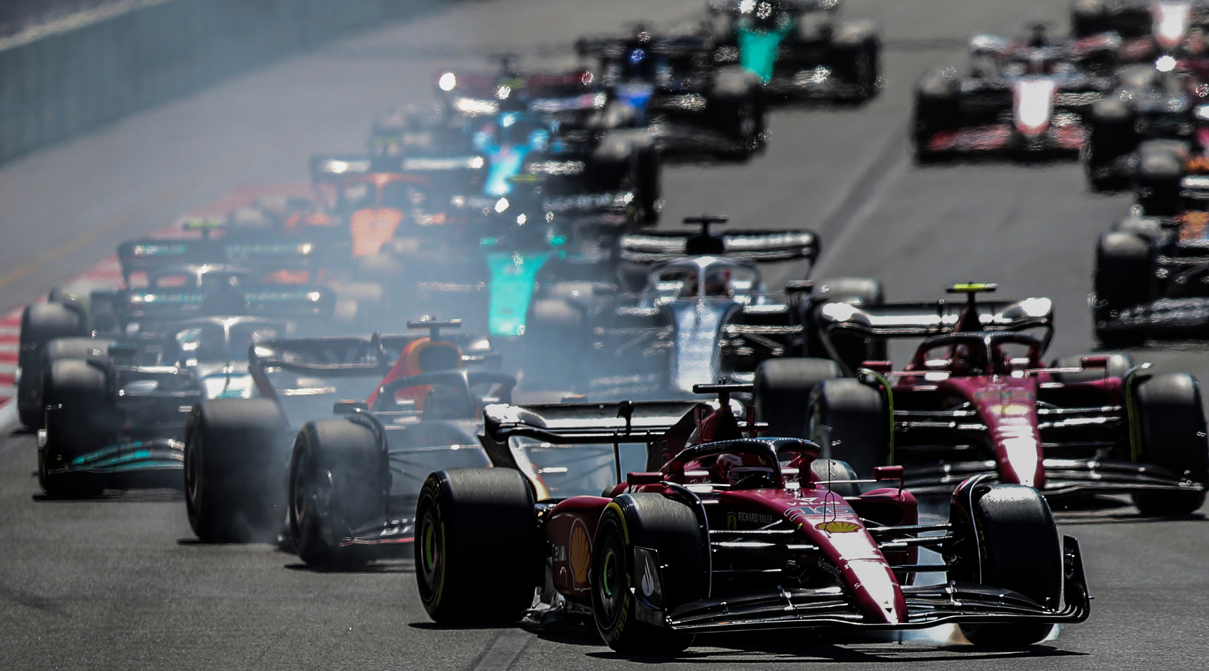 epa10009697 Smoke coming from the car of Monaco's Formula One driver Charles Leclerc (Front) of Scuderia Ferrari during the 2022 Formula One Grand Prix of Azerbaijan at the Baku circuit, Azerbaijan, 12 June 2022.  EPA-EFE/ALI HAIDER