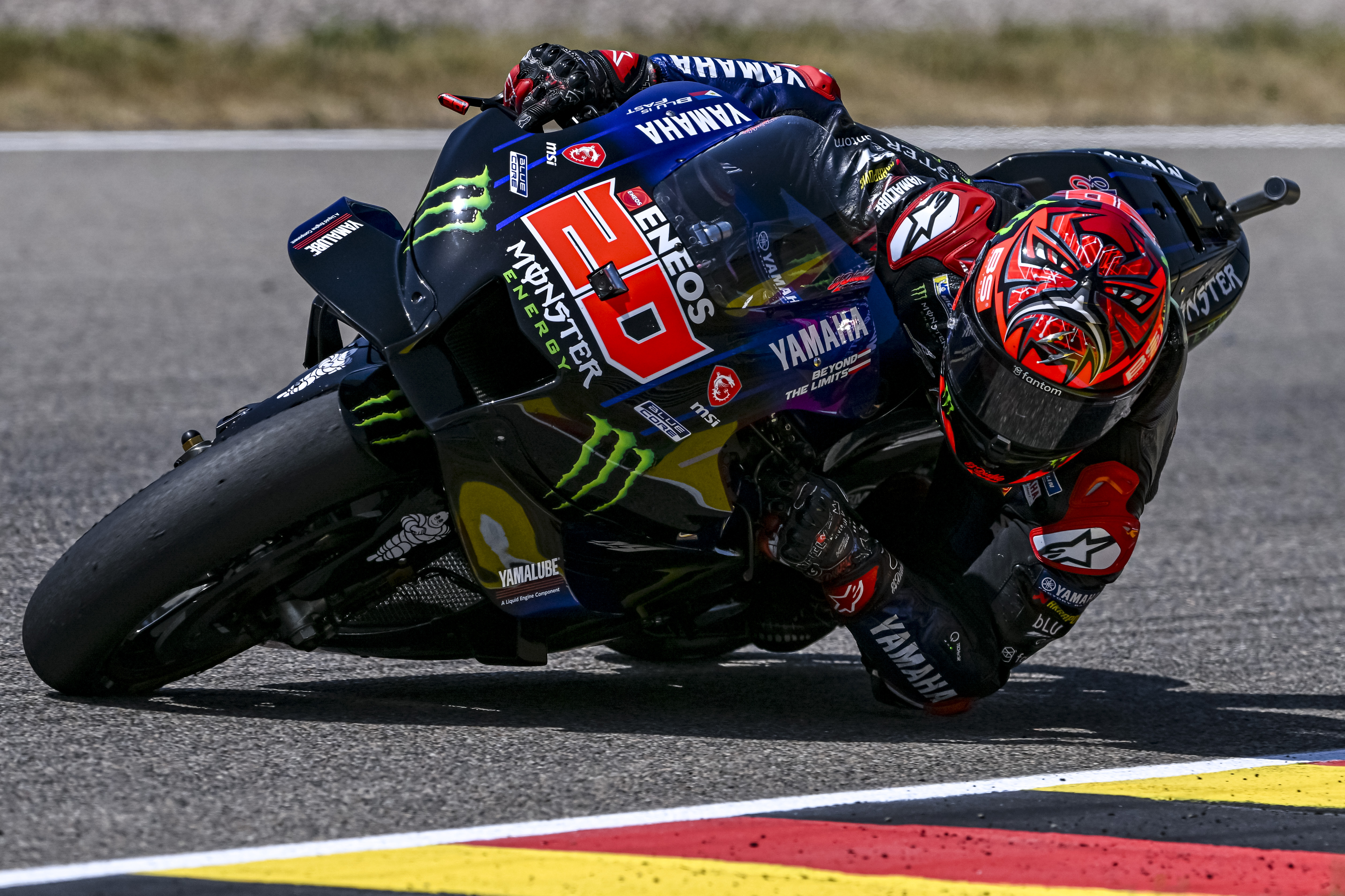 epa10022030 French MotoGP rider Fabio Quartararo of Monster Energy Yamaha MotoGP team in action during the Motorcycling Grand Prix of Germany at the Sachsenring racing circuit in Hohenstein-Ernstthal, Germany, 19 June 2022.  EPA-EFE/FILIP SINGER