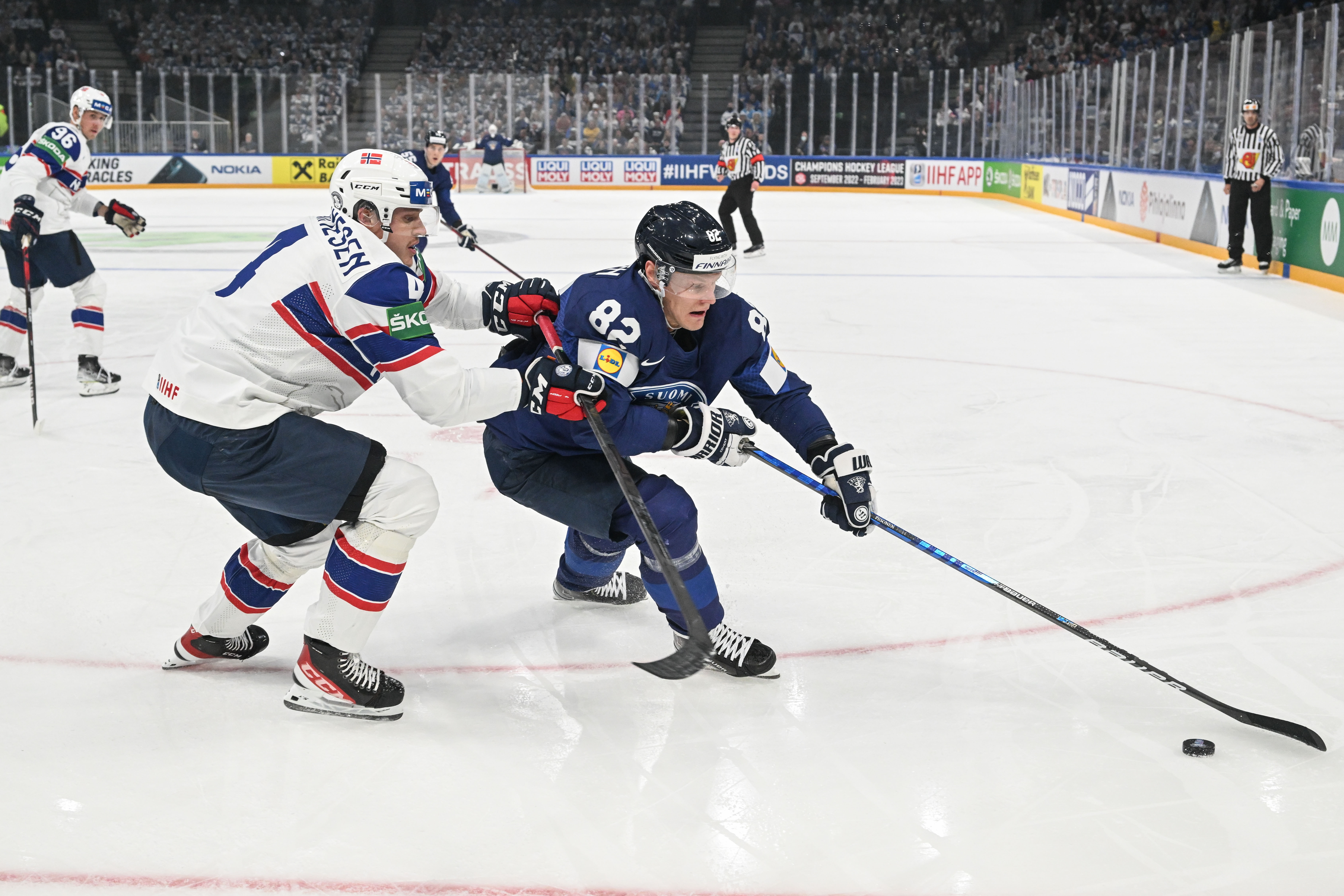 epa09945513 Harri Pesonen (R) from Finland in action during the preliminary round group B match between Finland and Norway at the IIHF Ice Hockey World Championship 2022 in Tampere, Finland, 13 May 2022.  EPA-EFE/KIMMO BRANDT