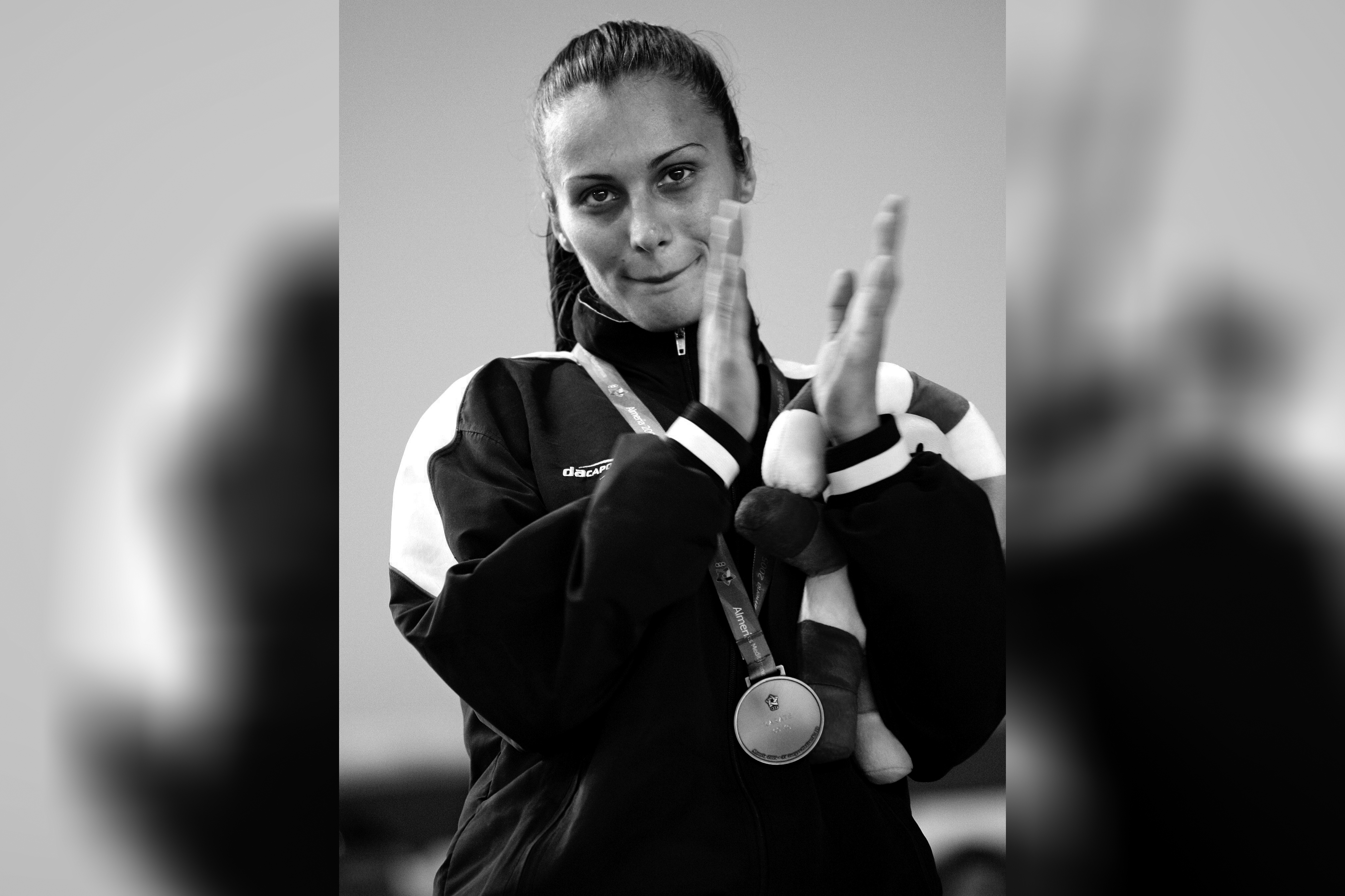 epa000466570 Serbian Snezana Peric claps on the podium after winning the gold medal in the Women's Karate - 60 kilogramme category at the 15th Mediterranean Games held in Almeria, Spain: Sunday 26 June 2005.  EPA/JUAN CARLOS CARDENAS