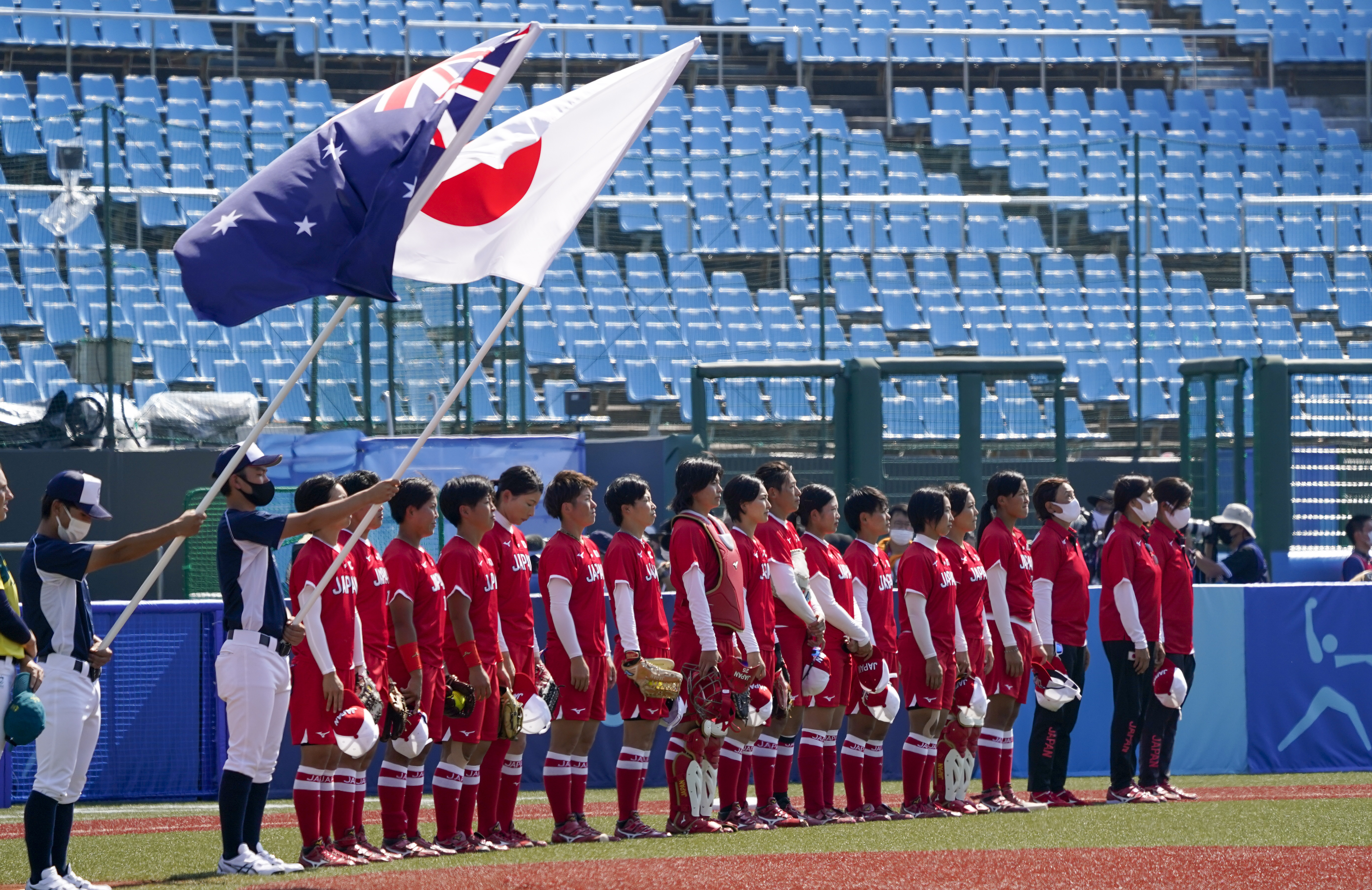 Japan players line up ahead of the softball game against Australia at the 2020 Summer Olympics, Wednesday, July 21, 2021, in Fukushima, Japan. (AP Photo/Jae C. Hong)