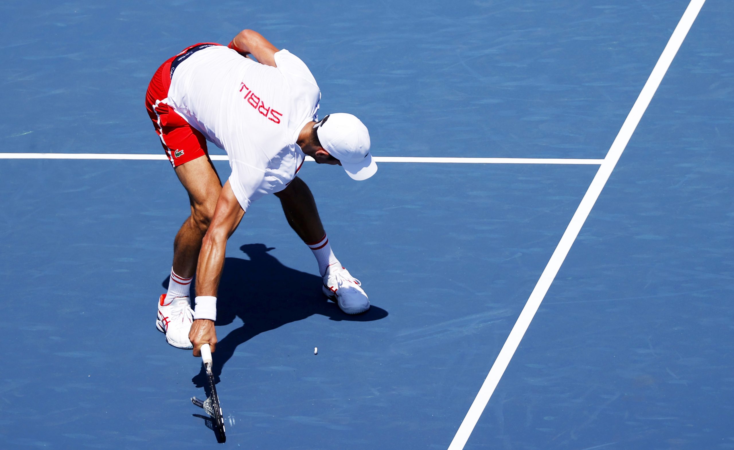 epa09357525 Novak Djokovic of Serbia smashes his racket during a training session at the Ariake Coliseum in Tokyo, Japan, 22 July 2021. The Tokyo 2020 Olympic Games start on 23 July.  EPA-EFE/VALDRIN XHEMAJ