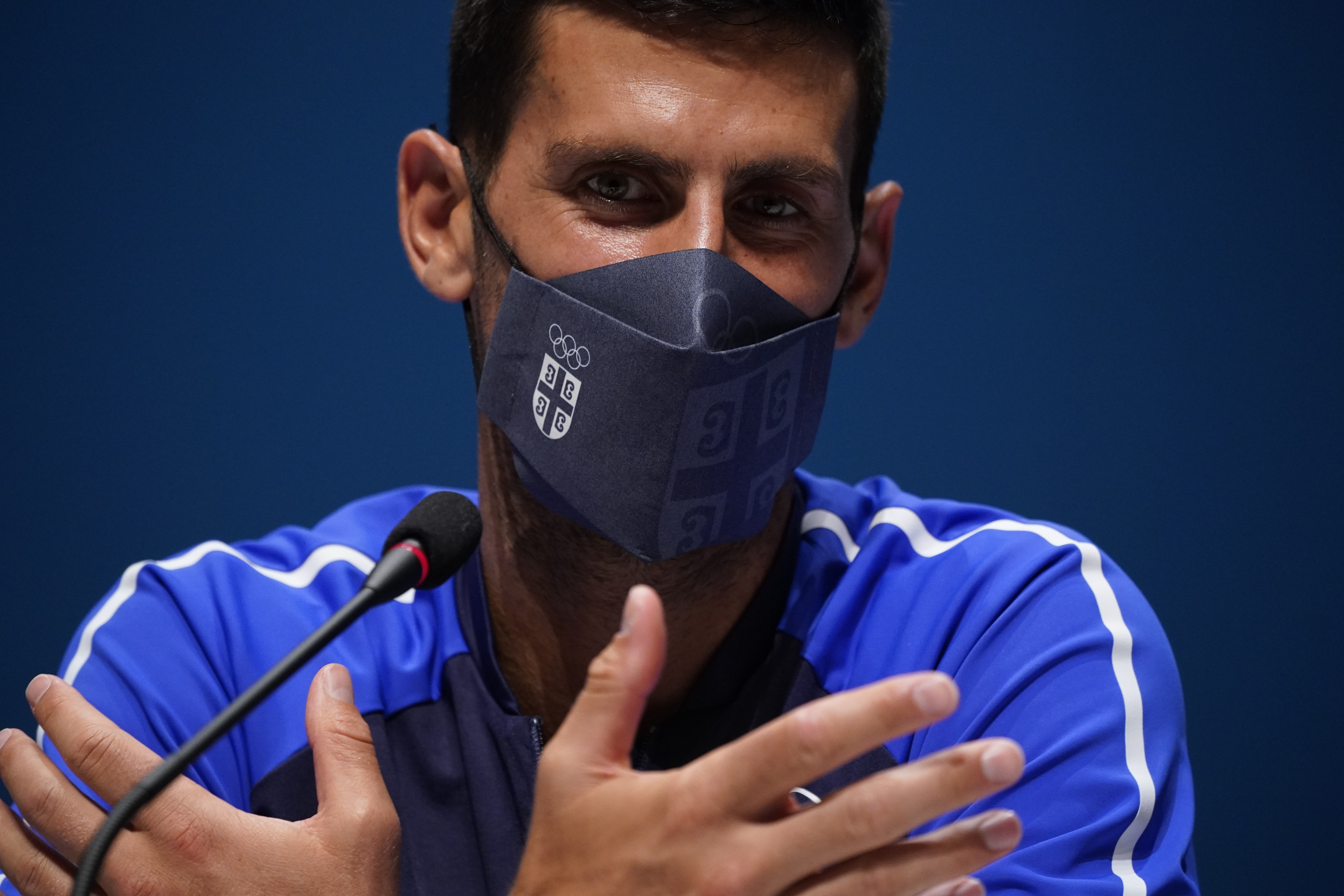 epa09357988 Novak Djokovic of Serbia wearing a face mask gestures during a press conference at the main press center in Tokyo, Japan, 22 July 2021. The Tokyo 2020 Olympic Games start on 23 July.  EPA-EFE/FRANCK ROBICHON