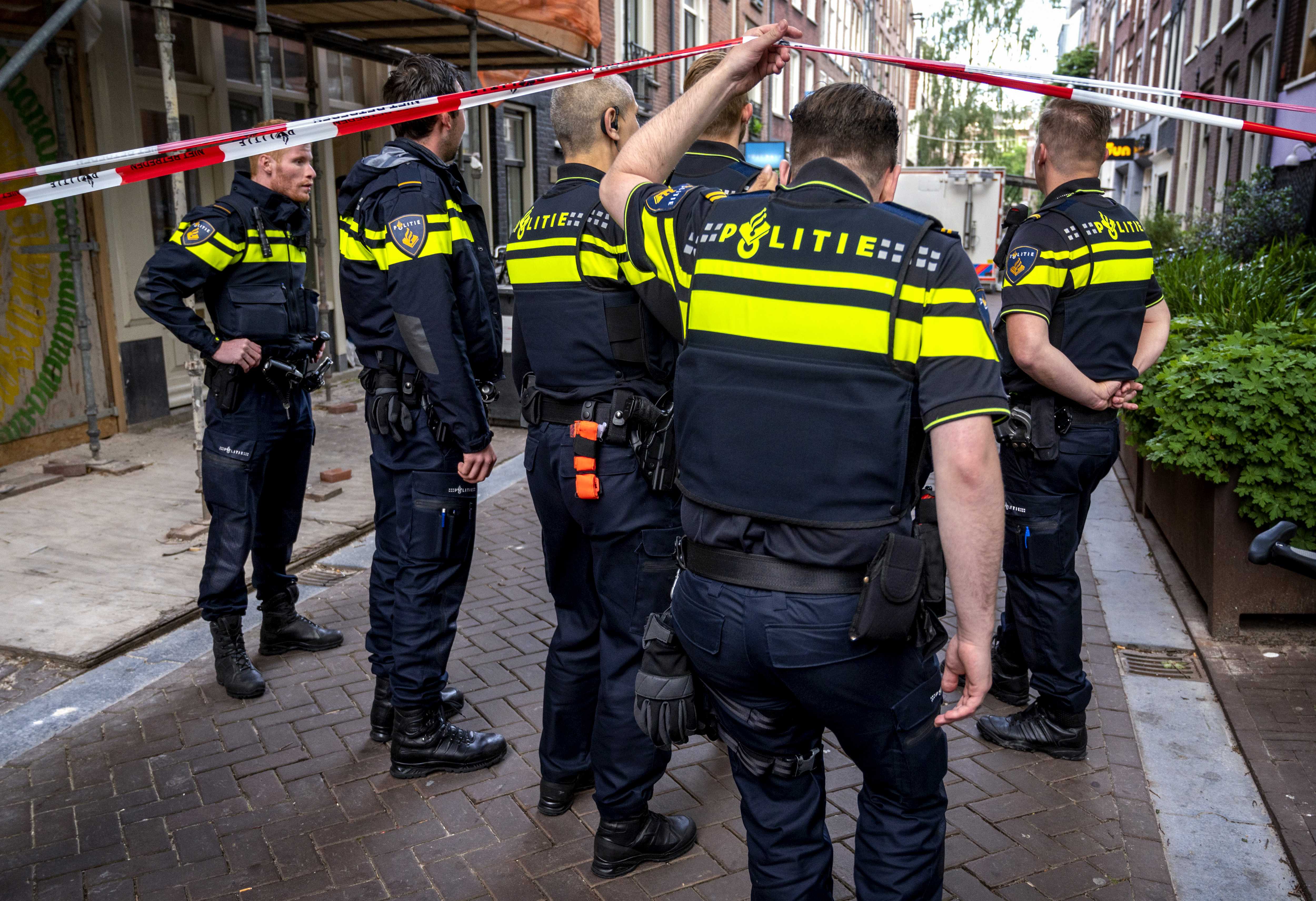 epa09327496 Police in the vicinity of the Lange Leidsedwarsstraat in Amsterdam, the Netherlands, 06 July 2021, where crime reporter Peter R. de Vries was seriously injured in a shooting.  EPA-EFE/EVERT ELZINGA