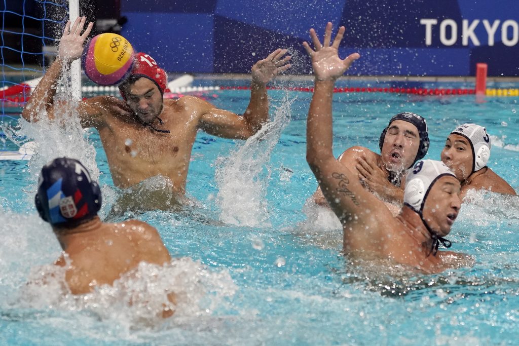 Kazakhstan goalkeeper Pavel Lipilin (13) blocks a shot by Serbia's Strahinja Rasovic (7) during a preliminary round men's water polo match at the 2020 Summer Olympics, Tuesday, July 27, 2021, in Tokyo, Japan. (AP Photo/Mark Humphrey)