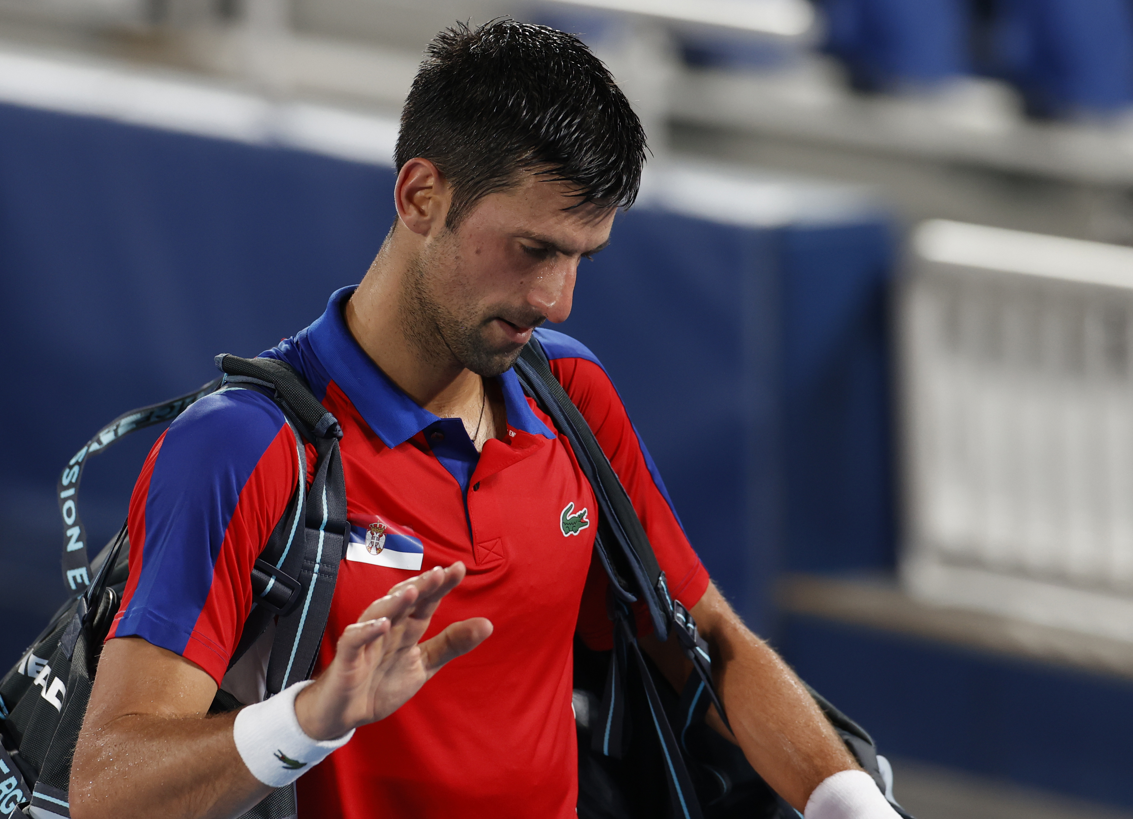 epa09379441 Novak Djokovic of Serbia leaves the court after his loss to Alexander Zverev of Germany at the Men's Singles Semifinal Tennis events of the Tokyo 2020 Olympic Games at the Ariake Coliseum in Tokyo, Japan, 30 July 2021.  EPA-EFE/RUNGROJ YONGRIT