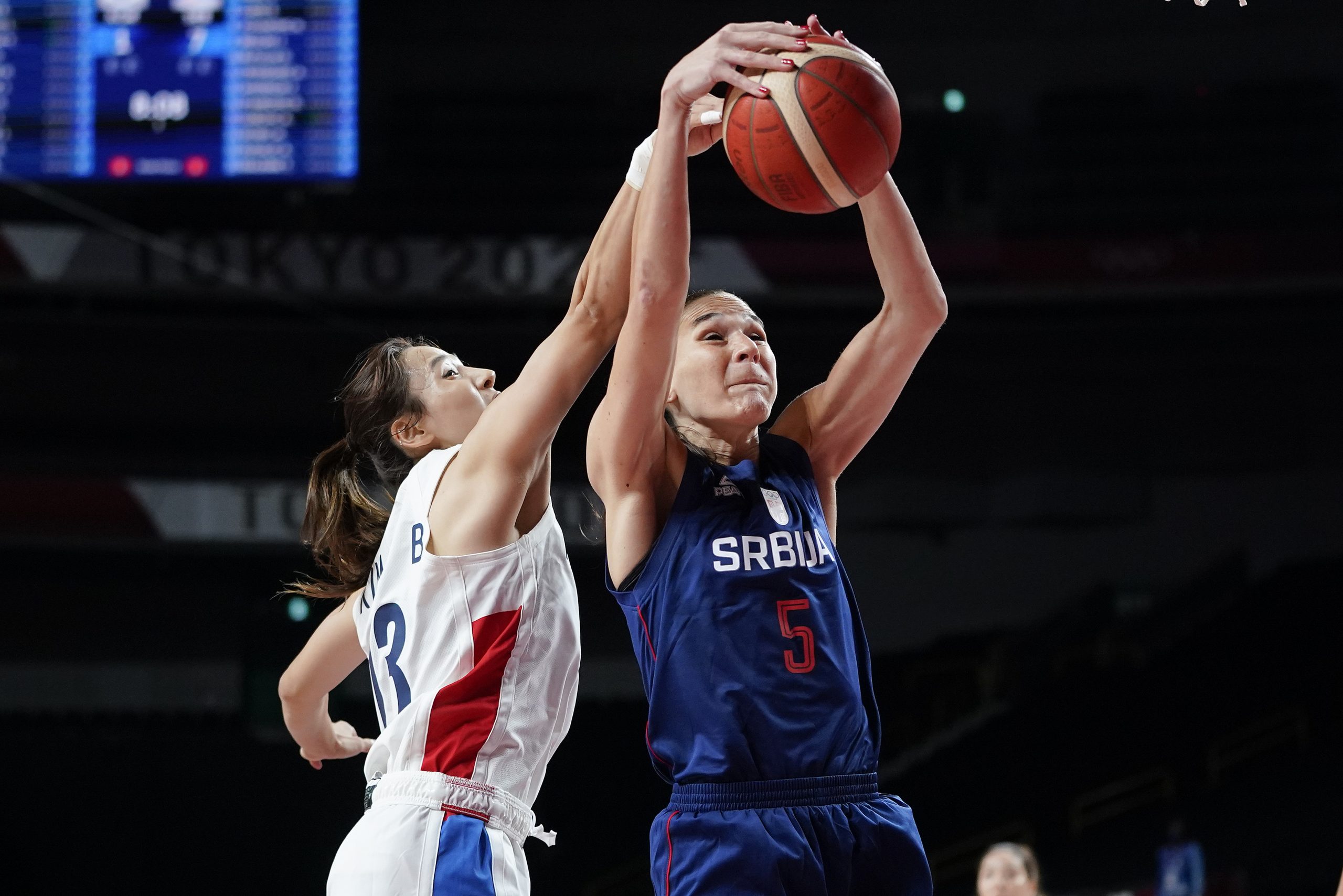 Serbia's Ana Dabovic (23) and Serbia's Sonja Vasic (5) fight for a rebound during the first half of a women's preliminary round basketball at the 2020 Summer Olympics, Sunday, Aug. 1, 2021, in Saitama, Japan. (AP Photo/Charlie Neibergall)