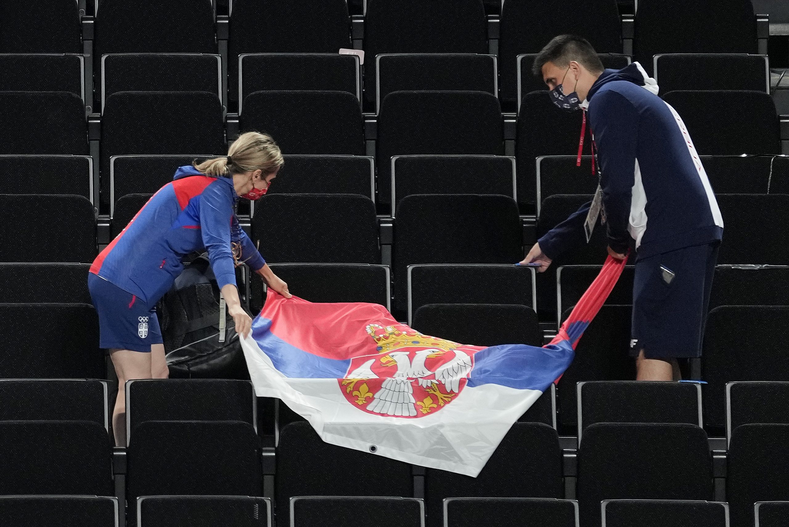 Serbian fans lay out their countries flag before watching the women's Serbian national basketball team play against South Korea at the 2020 Summer Olympics, Sunday, Aug. 1, 2021, in Saitama, Japan. (AP Photo/Eric Gay)