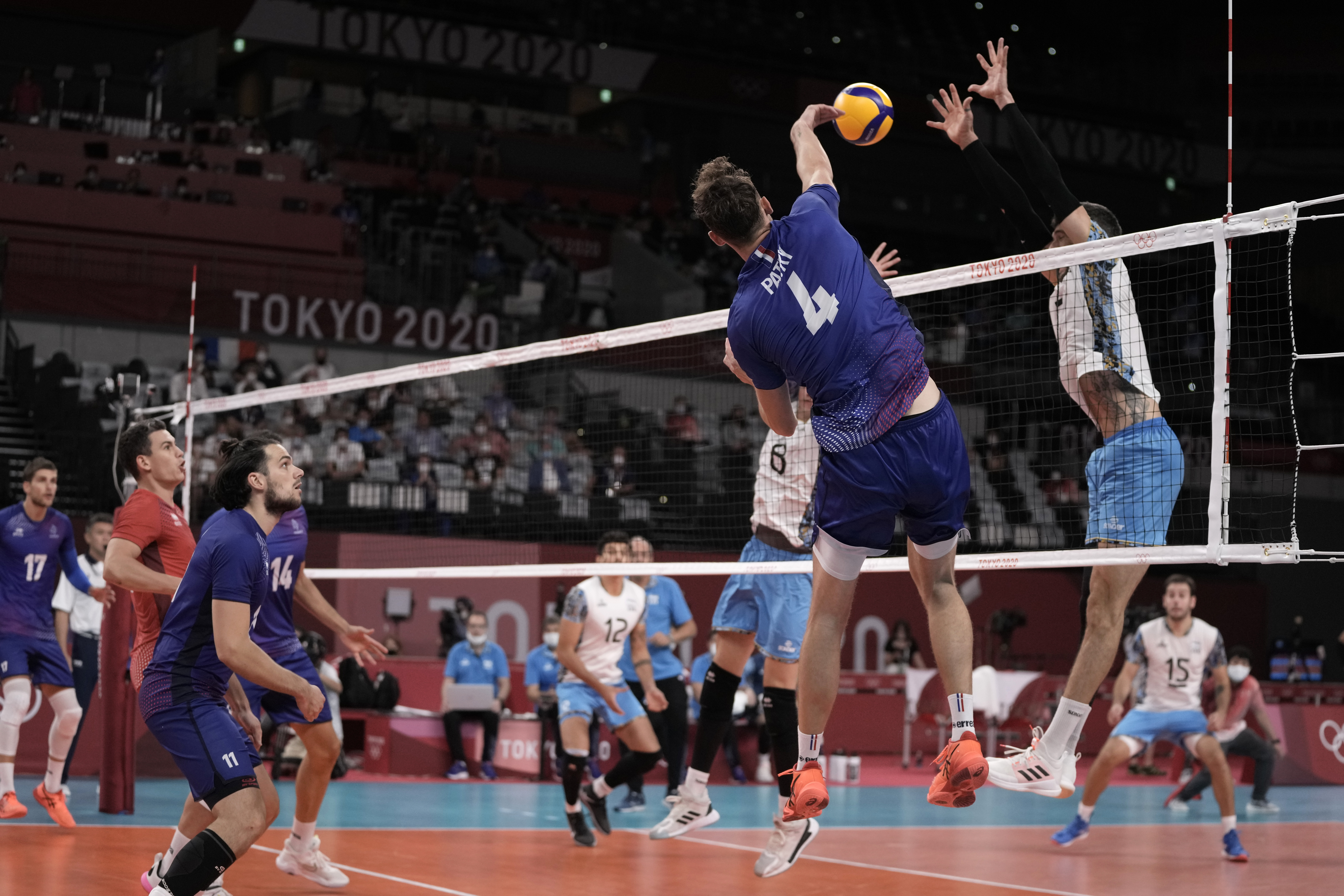 France's Jean Patry spikes a ball against Argentina's Bruno Lima, during a men's volleyball semifinal match, at the 2020 Summer Olympics, Thursday, Aug. 5, 2021, in Tokyo, Japan. (AP Photo/Manu Fernandez)