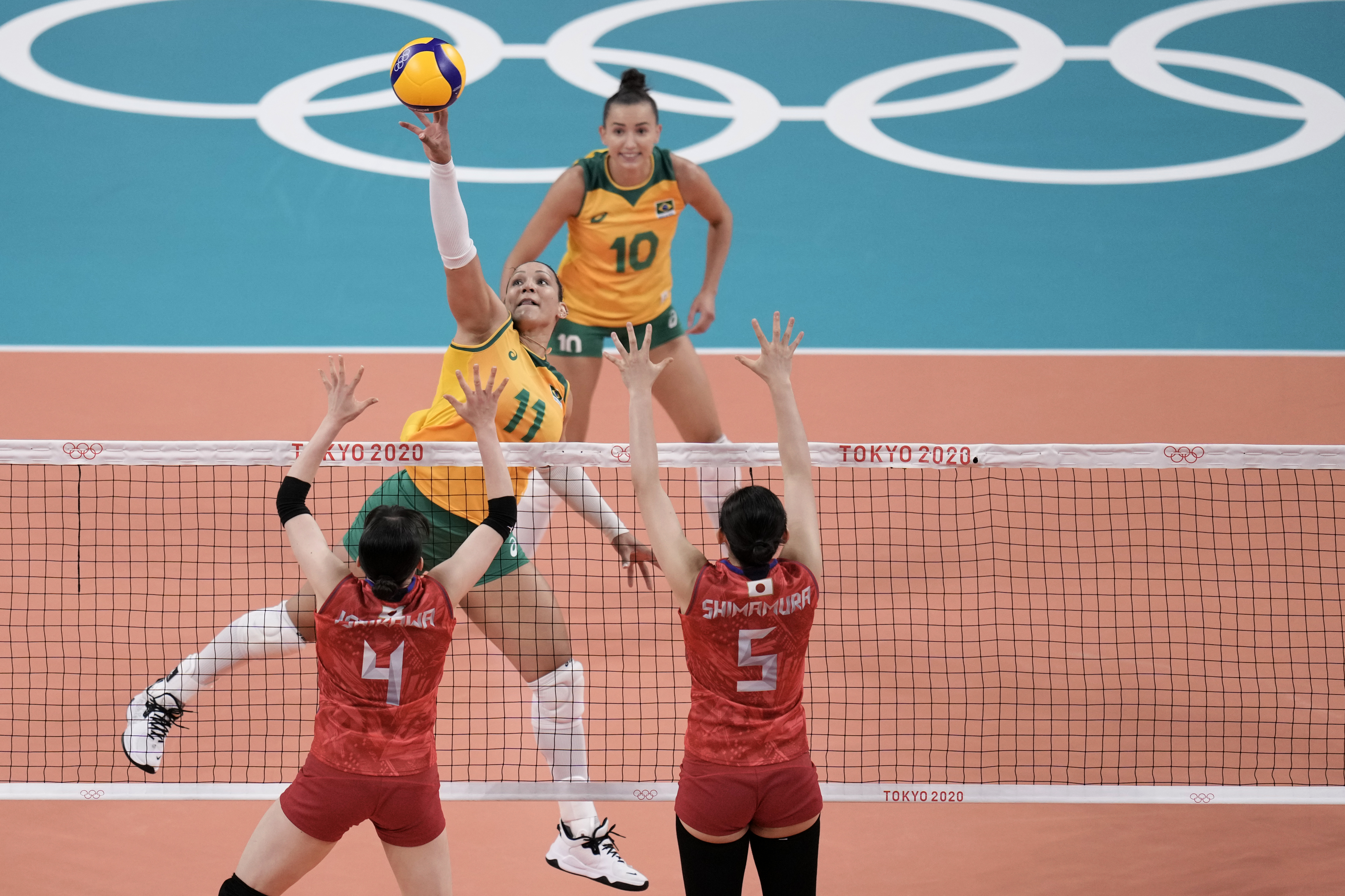 Brazil's Tandara Caixeta returns a ball against Japan's Mayu Ishikawa and Haruyo Shimamura, during a women's volleyball preliminary round pool A match, at the 2020 Summer Olympics, Thursday, July 29, 2021, in Tokyo, Japan. (AP Photo/Manu Fernandez)