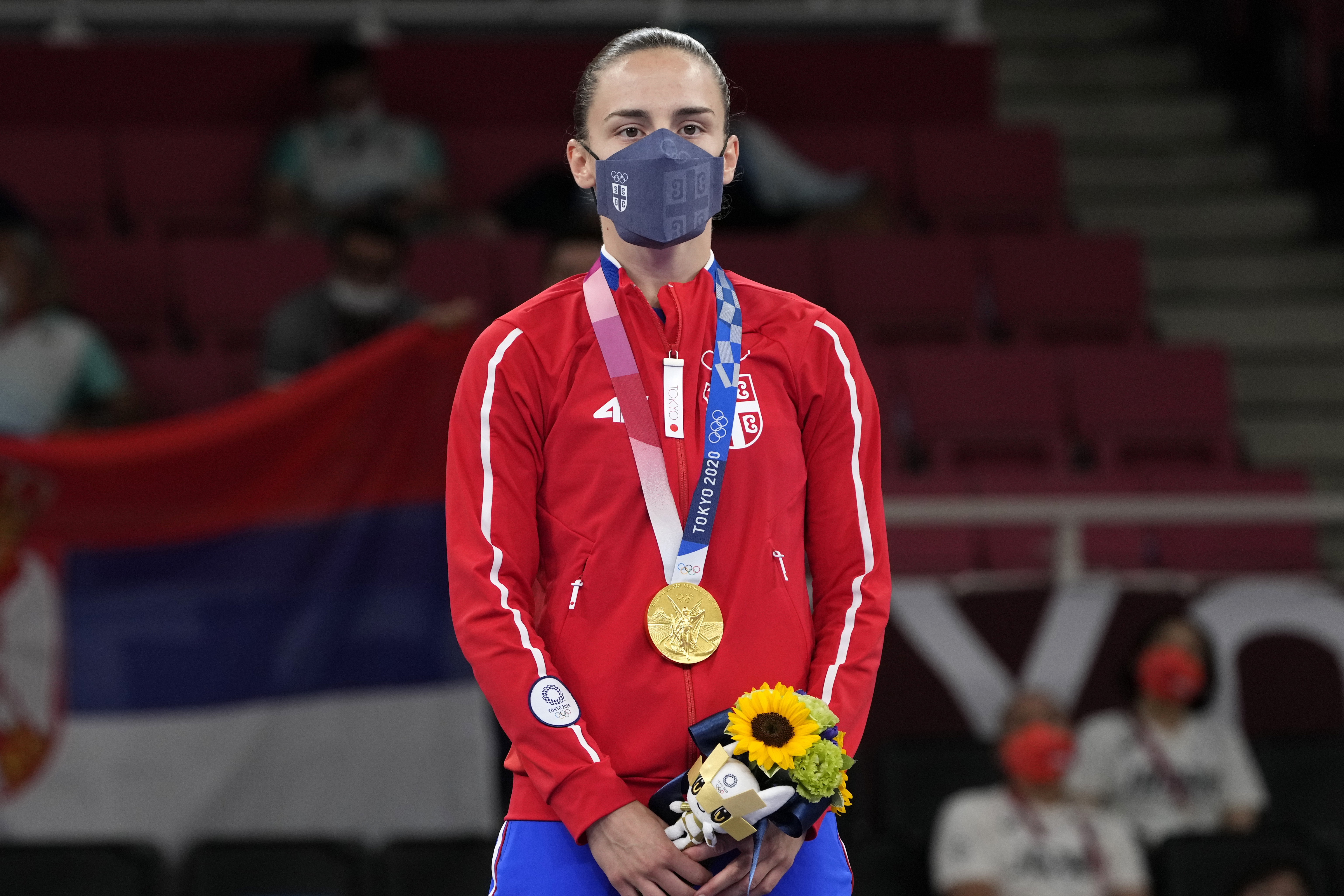 Gold medalist Jovana Prekovic of Serbia stands during the medal ceremony for women's kumite -61kg karate at the 2020 Summer Olympics, Friday, Aug. 6, 2021, in Tokyo, Japan. (AP Photo/Vincent Thian)