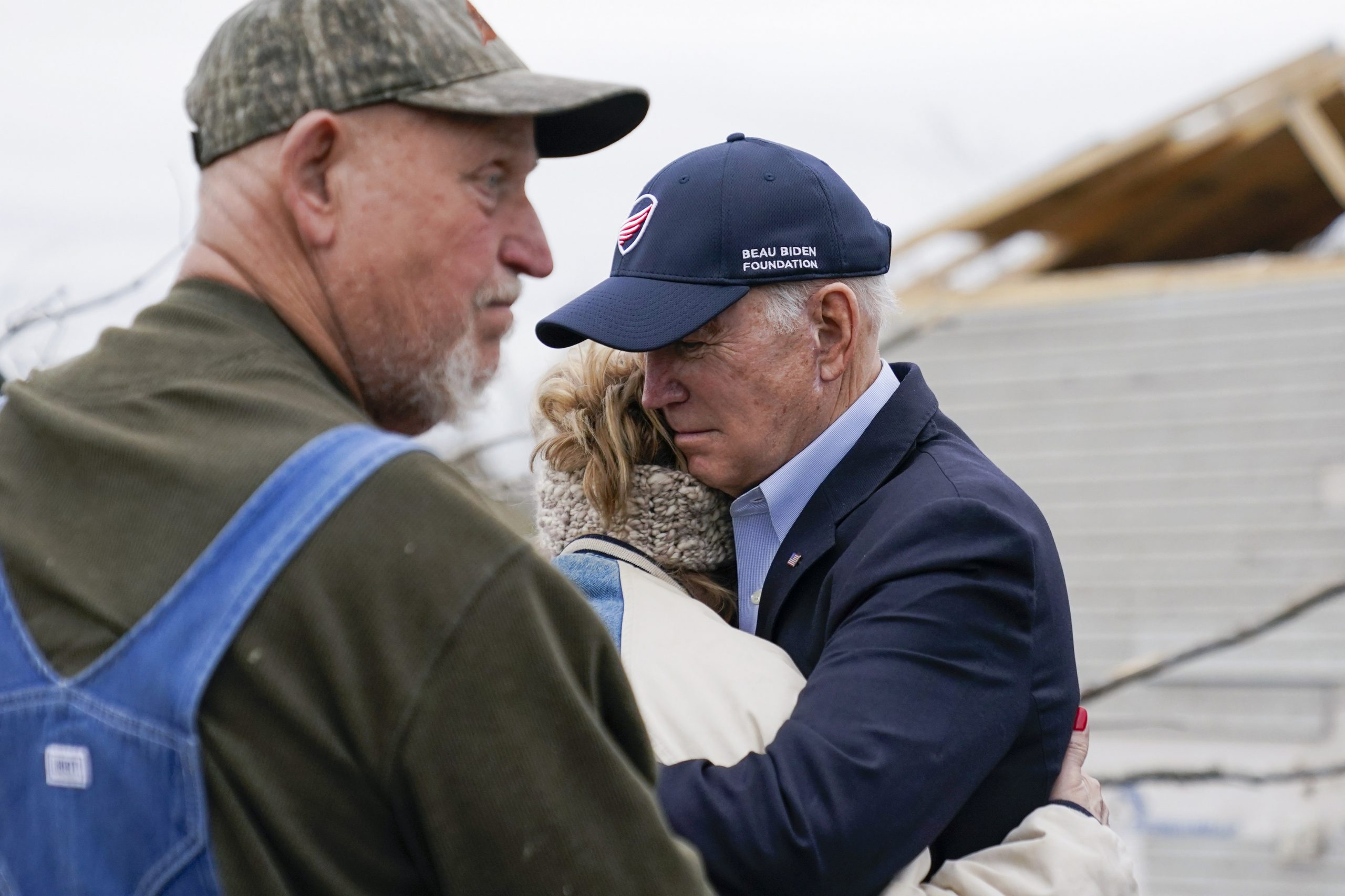 President Joe Biden hugs a person while visiting the area to survey storm damage from tornadoes and extreme weather in Dawson Springs, Ky., Wednesday, Dec. 15, 2021. (AP Photo/Andrew Harnik)